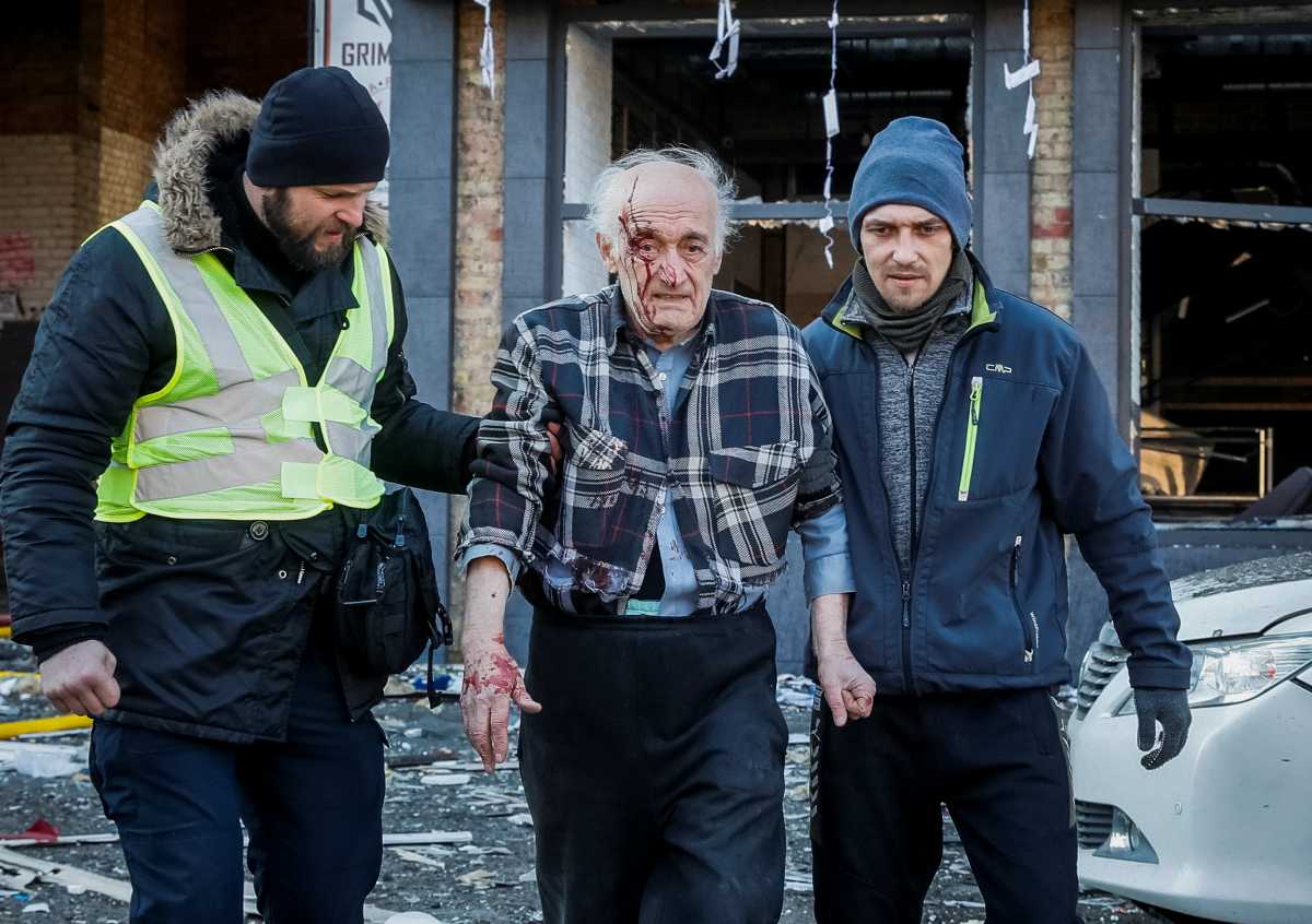 SENSITIVE MATERIAL. THIS IMAGE MAY OFFEND OR DISTURB People help a wounded resident of a house destroyed by shelling as Russia's attack on Ukraine continues, in Kyiv, Ukraine March 14, 2022. REUTERS