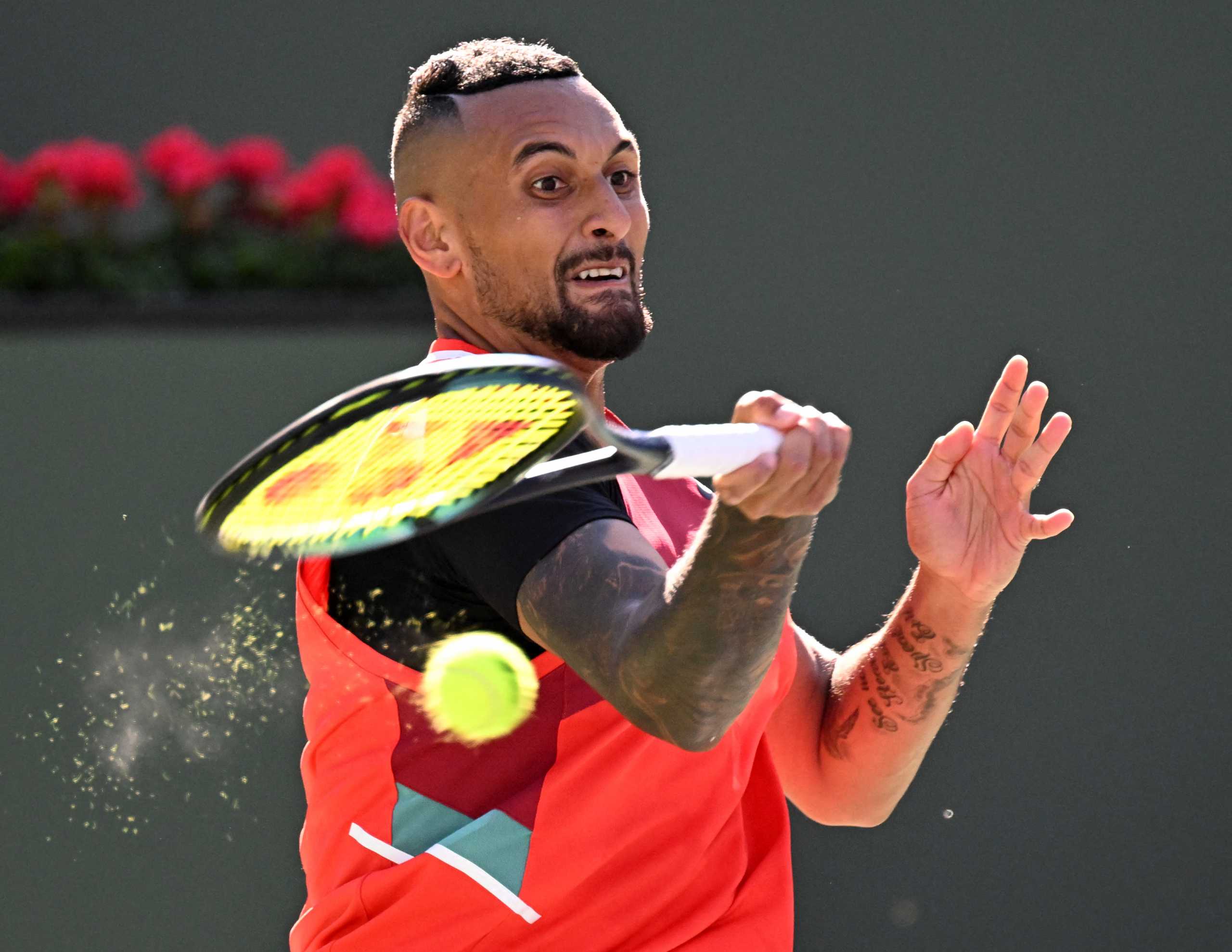 Mar 17, 2022; Indian Wells, CA, USA;  Nick Kyrgios (AUS) hits a shot in his quarterfinal match against Rafael Nadal (ESP) at the BNP Paribas Open at the Indian Wells Tennis Garden. Mandatory Credit: Jayne Kamin-Oncea-USA TODAY Sports