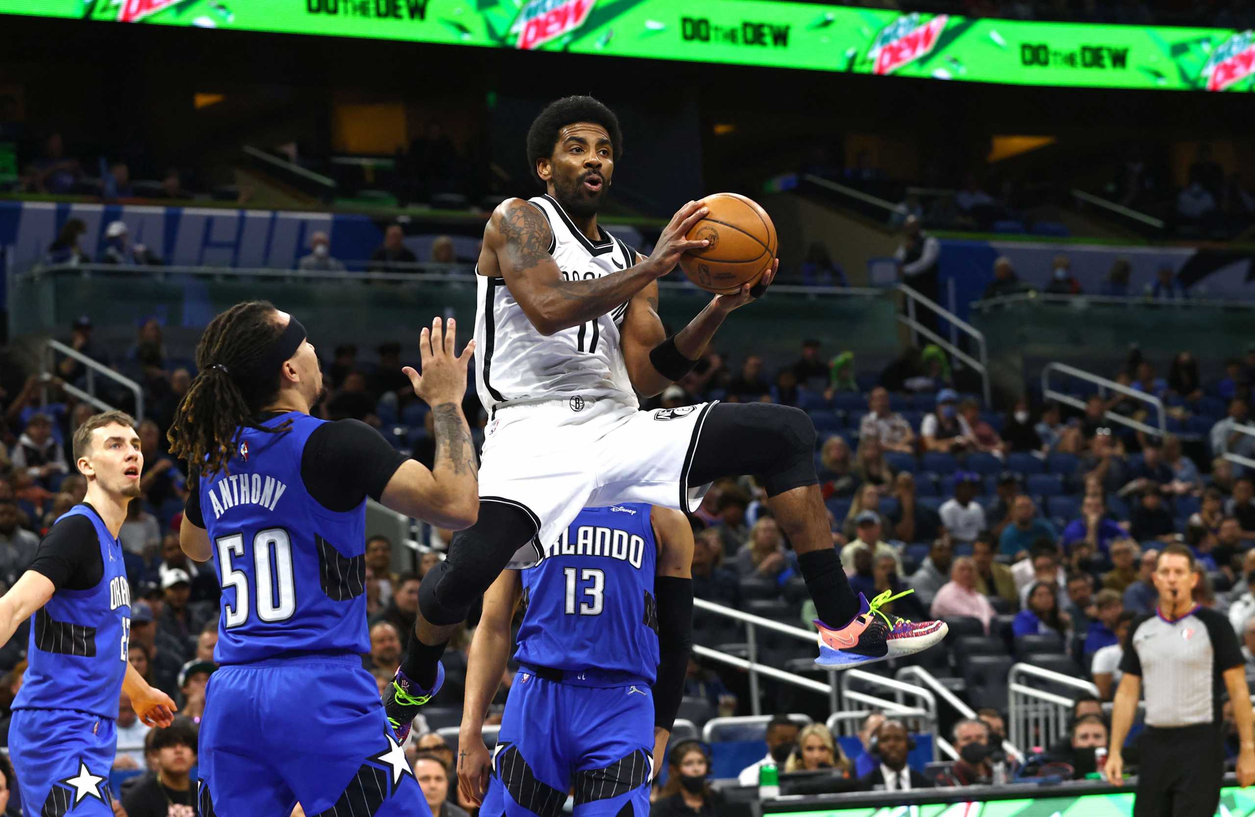 Mar 15, 2022; Orlando, Florida, USA; Brooklyn Nets guard Kyrie Irving (11) passes the ball against the Orlando Magic during the first quarter at Amway Center. Mandatory Credit: Kim Klement-USA TODAY Sports