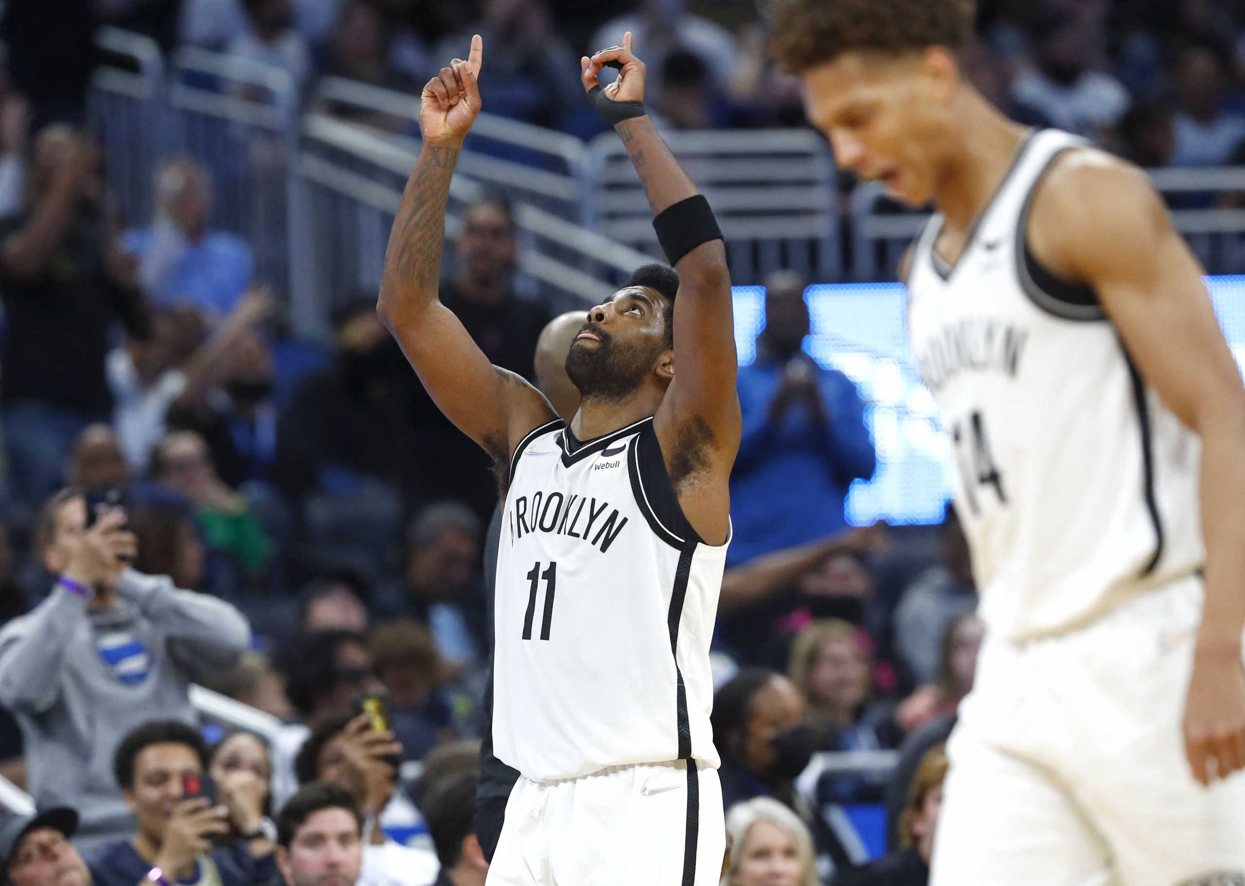 Mar 15, 2022; Orlando, Florida, USA; Brooklyn Nets guard Kyrie Irving (11) celebrates during the second half after scoring a career high 60 points against the Orlando Magic at Amway Center. Mandatory Credit: Kim Klement-USA TODAY Sports