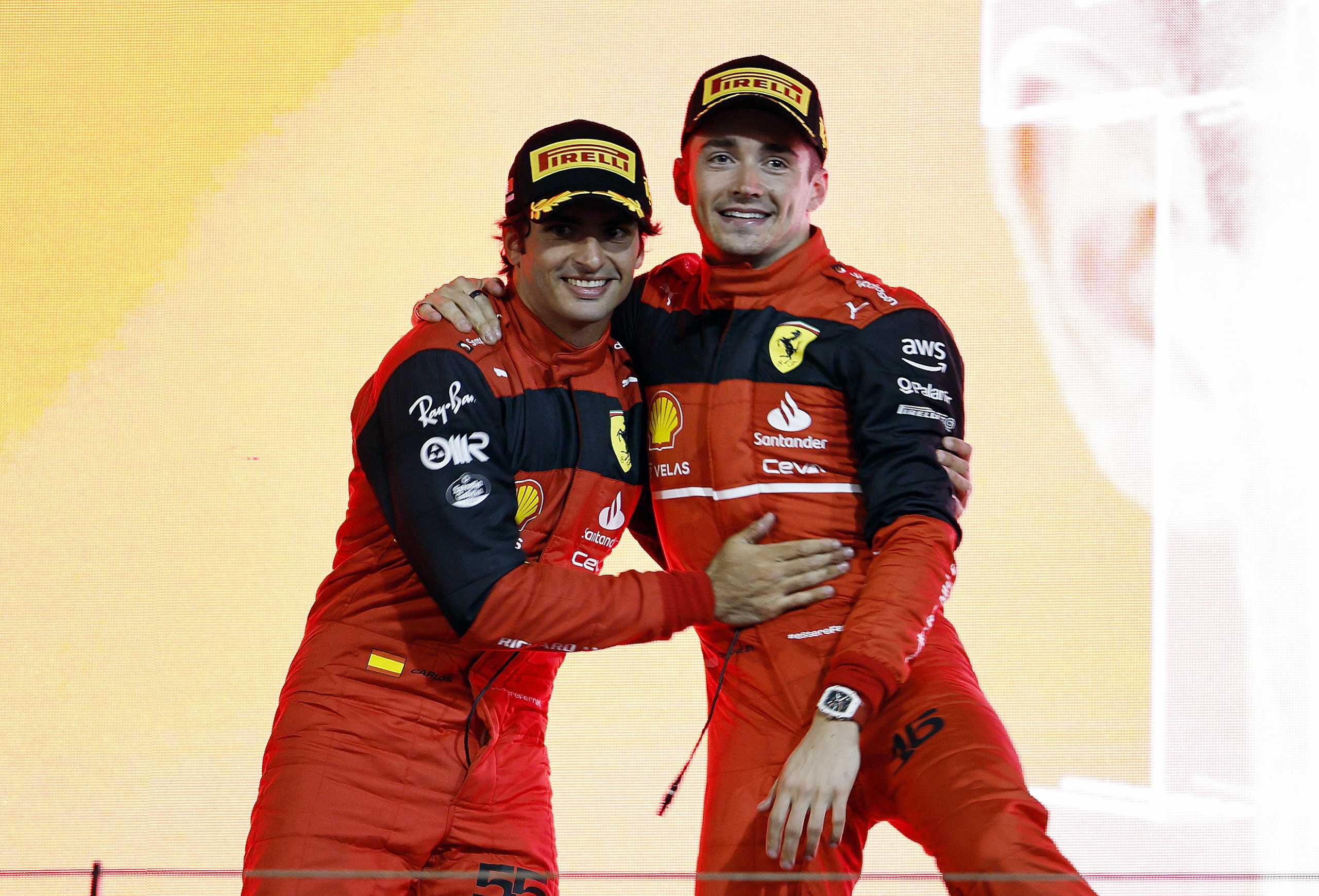 Formula One F1 - Bahrain Grand Prix - Bahrain International Circuit, Sakhir, Bahrain - March 20, 2022 Ferrari's Charles Leclerc celebrates on the podium after winning the race with second place Ferrari's Carlos Sainz Jr. REUTERS