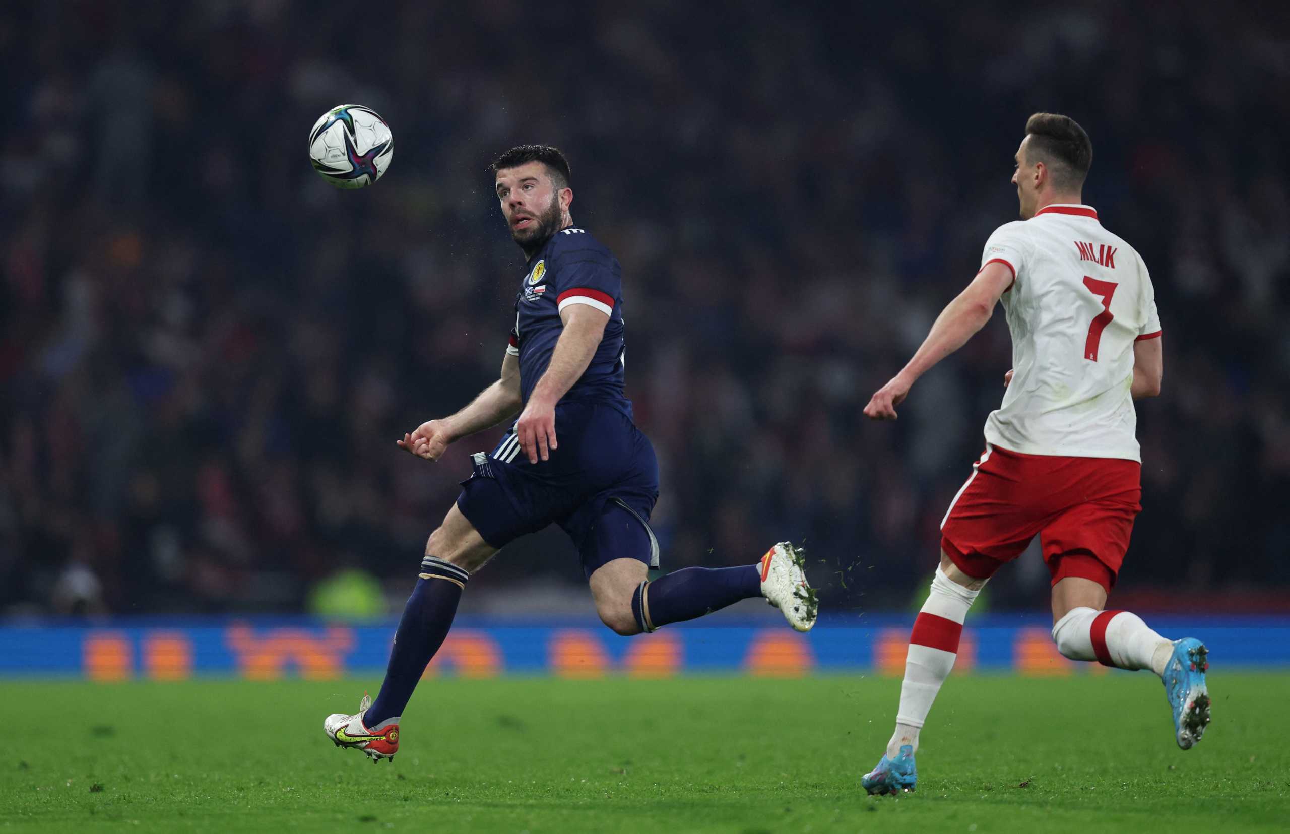 Soccer Football - International Friendly - Scotland v Poland - Hampden Park, Glasgow, Scotland, Britain - March 24, 2022 Scotland's Grant Hanley in action with Poland's Arkadiusz Milik REUTERS