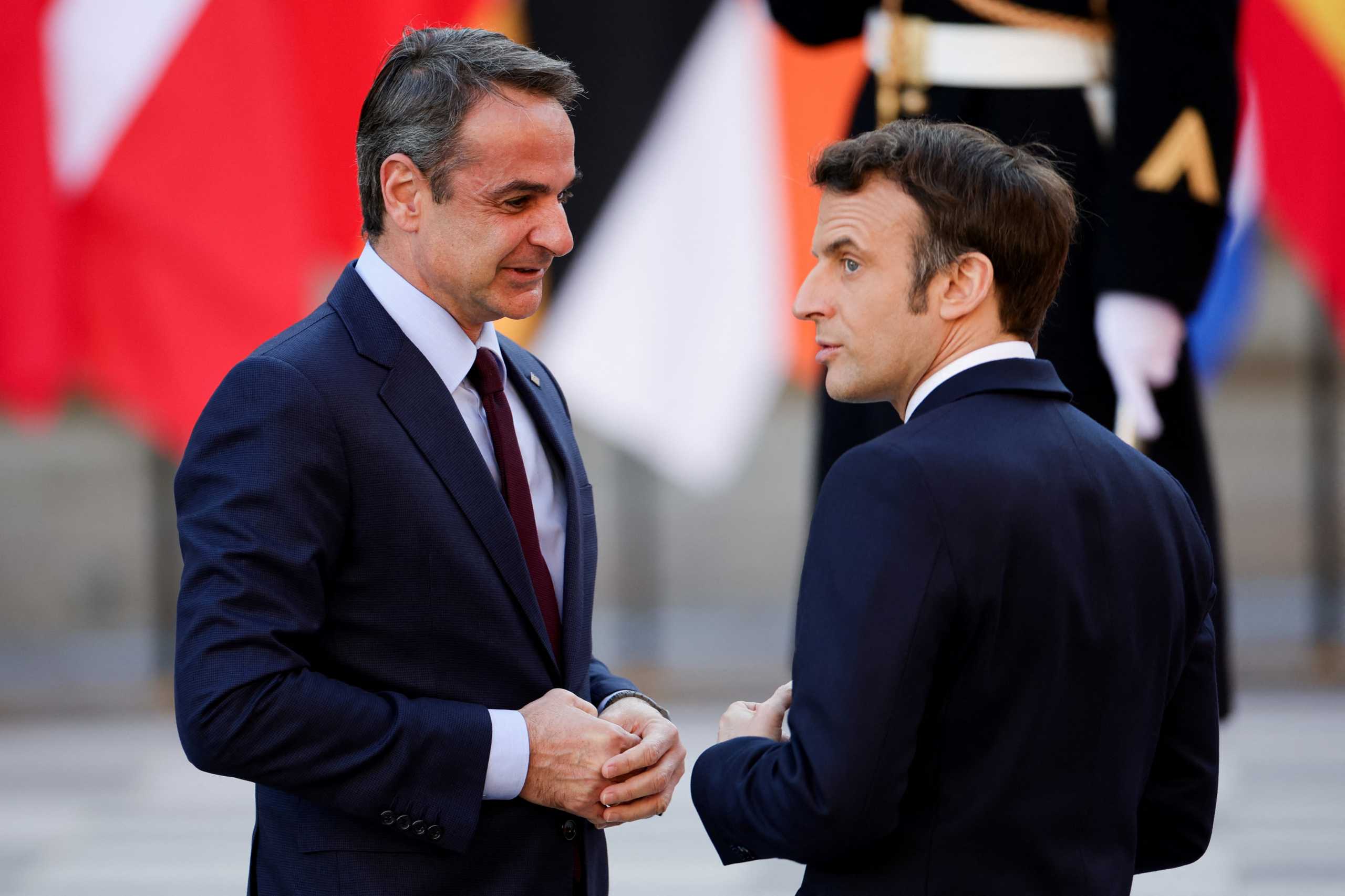 French President Emmanuel Macron welcomes Greek Prime Minister Kyriakos Mitsotakis as he arrives to attend an informal summit of EU leaders at the Chateau de Versailles (Versailles Palace), amid Russia's invasion of Ukraine, in Versailles, near Paris, France, March 10, 2022. REUTERS