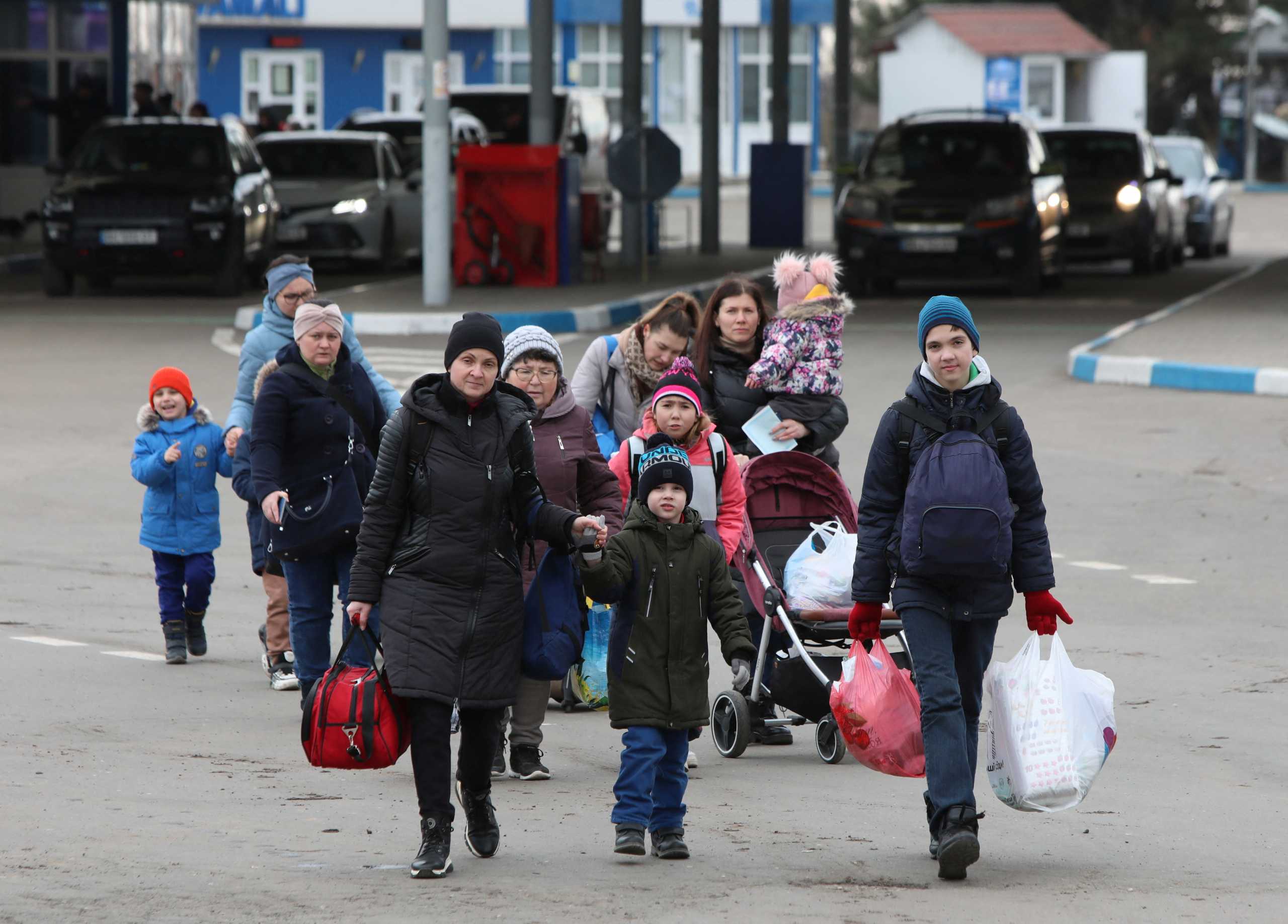 People walk after fleeing from Ukraine to Moldova during Ukraine-Russia conflict, at the border crossing in Tudora, Moldova March 6, 2022. REUTERS