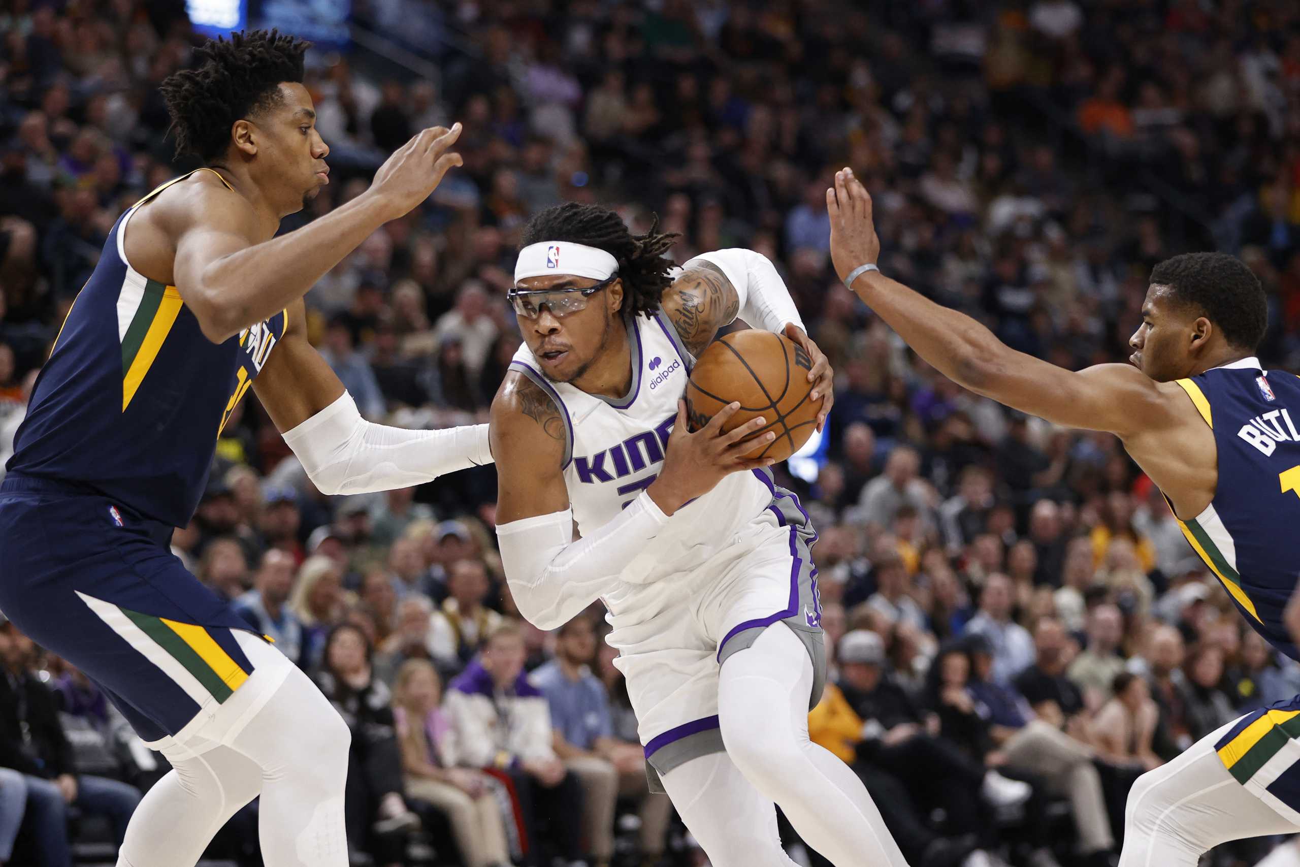 Mar 12, 2022; Salt Lake City, Utah, USA; Sacramento Kings center Richaun Holmes (22) drives against Utah Jazz center Hassan Whiteside (21) and guard Jared Butler (13) in the second quarter at Vivint Arena. Mandatory Credit: Jeffrey Swinger-USA TODAY Sports