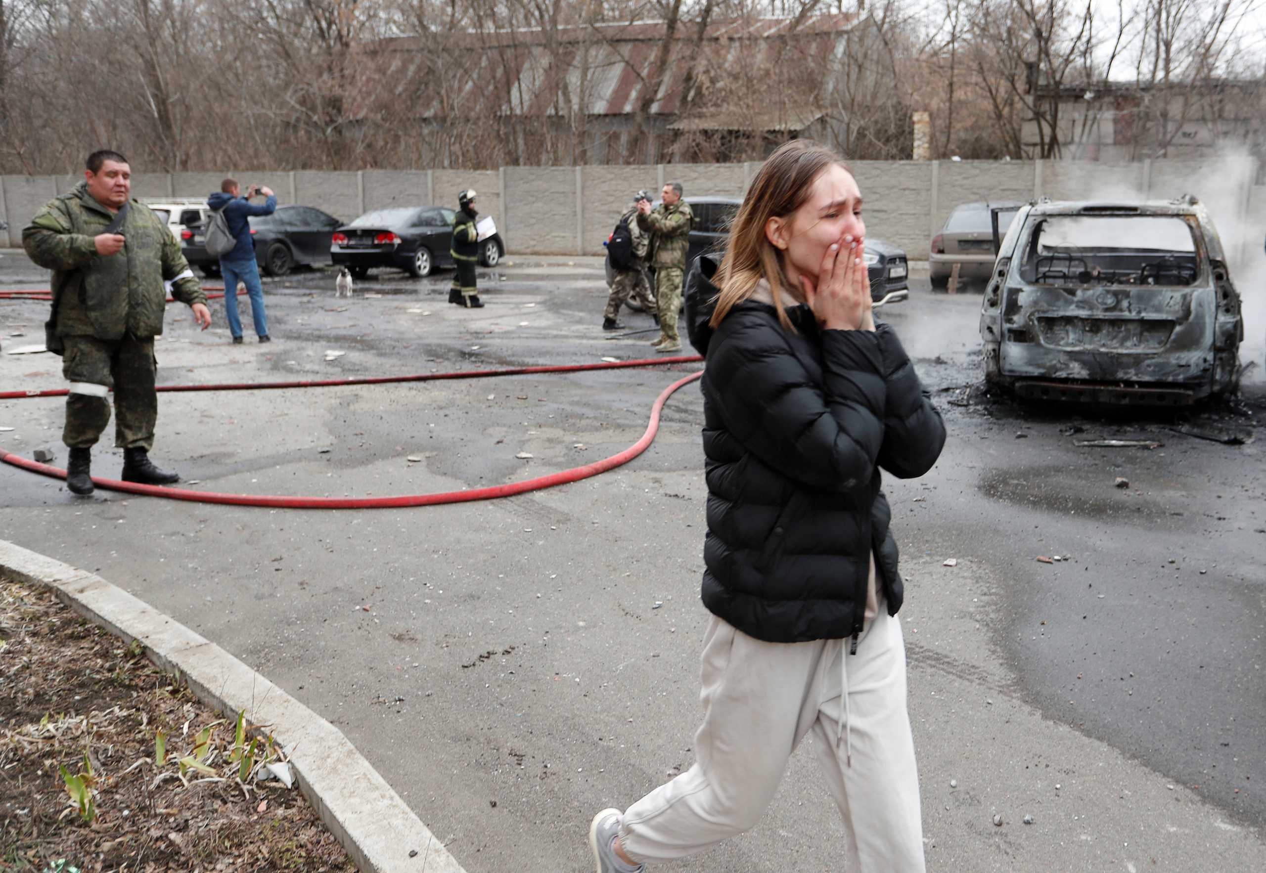 A woman reacts next to a residential building, which locals said was damaged by recent shelling, in the separatist-controlled city of Donetsk, Ukraine February 28, 2022. REUTERS