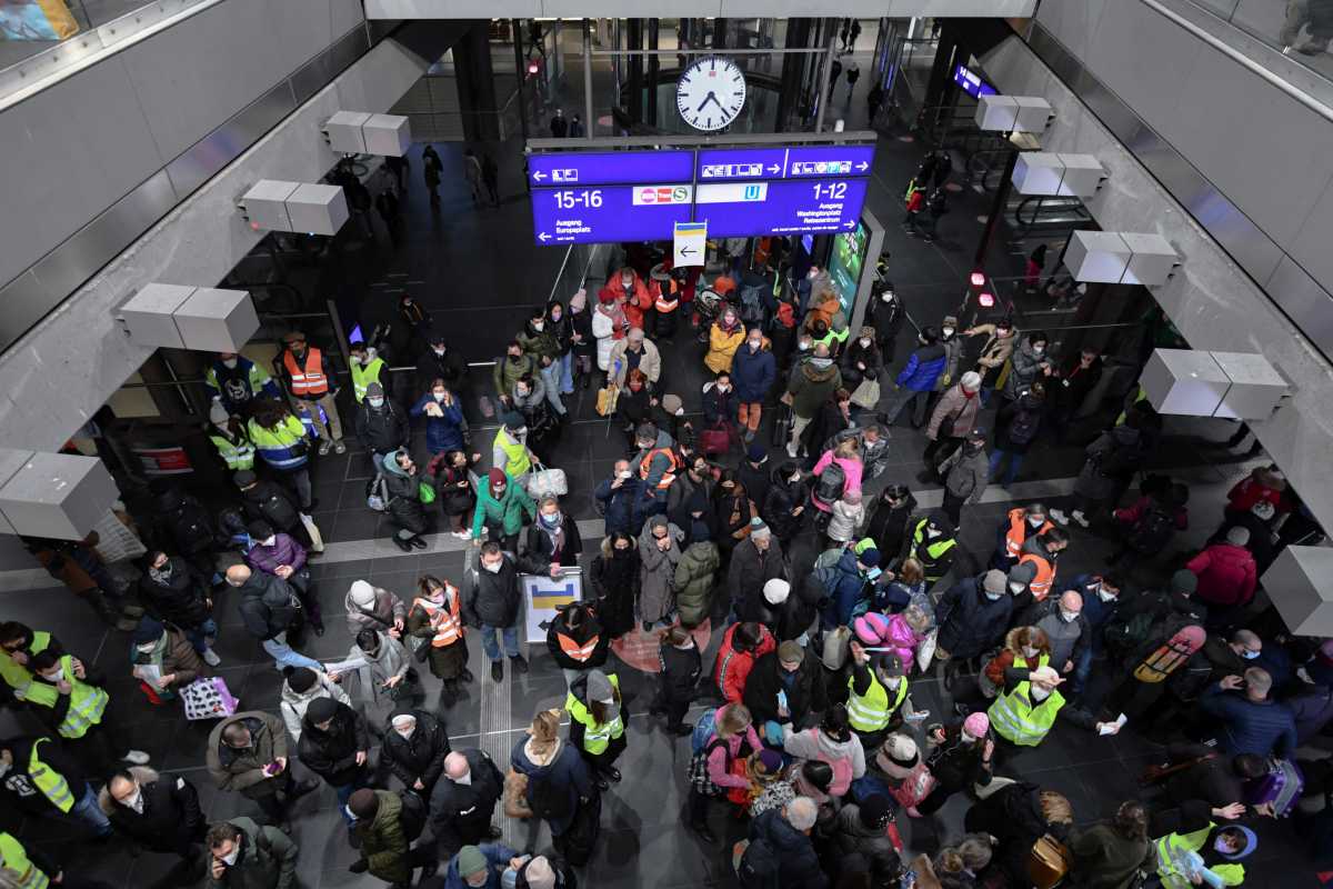 Volunteers in high-visibility clothing help refugees fleeing Russia's invasion of Ukraine who have arrived on a train from Poland at the central station in Berlin, Germany, March 6, 2022. REUTERS
