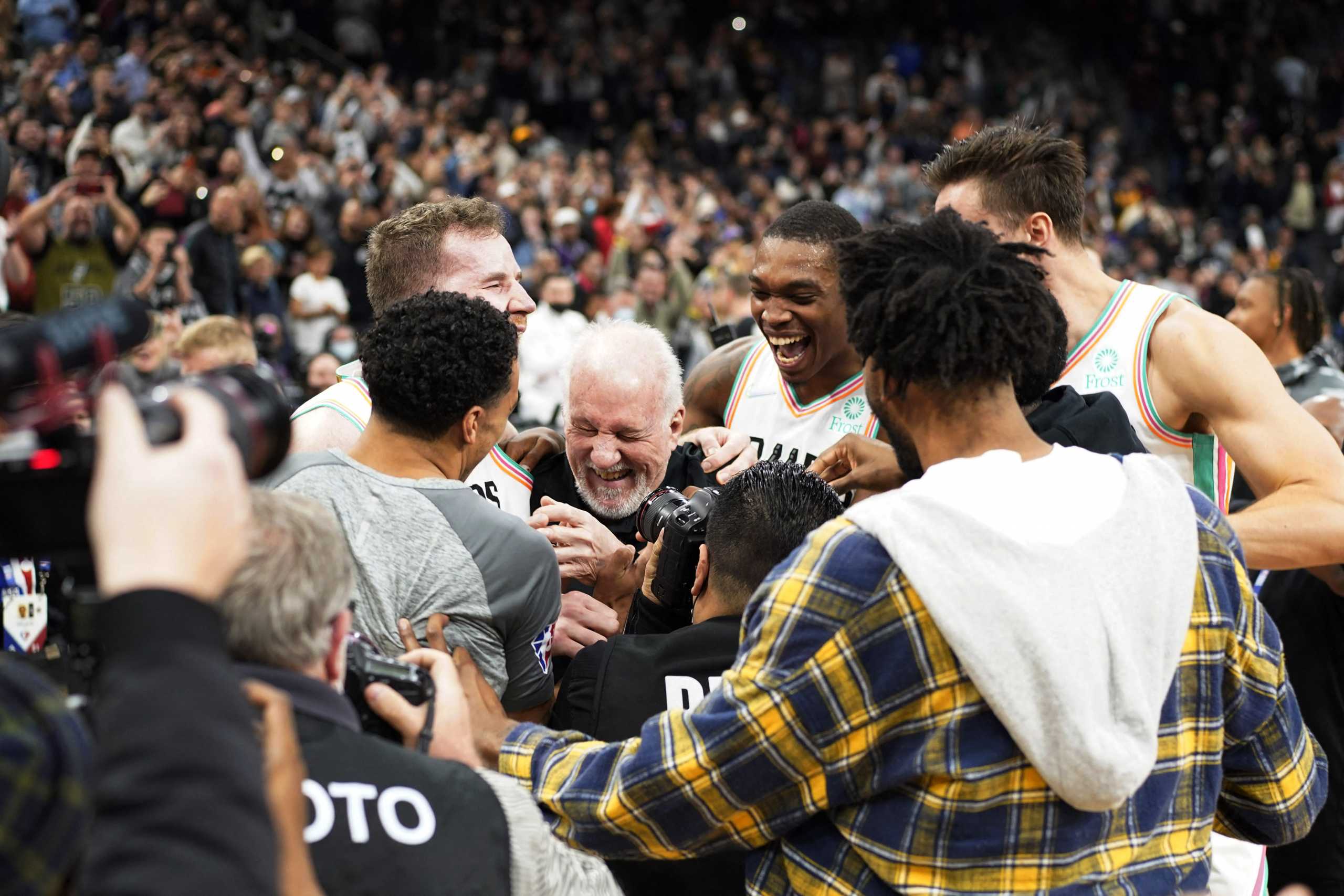 Mar 11, 2022; San Antonio, Texas, USA; San Antonio Spurs head coach Gregg Popovich is congratulated by players after becoming the winningest coach in NBA history after the game against the Utah Jazz at AT&T Center. Mandatory Credit: Scott Wachter-USA TODAY Sports