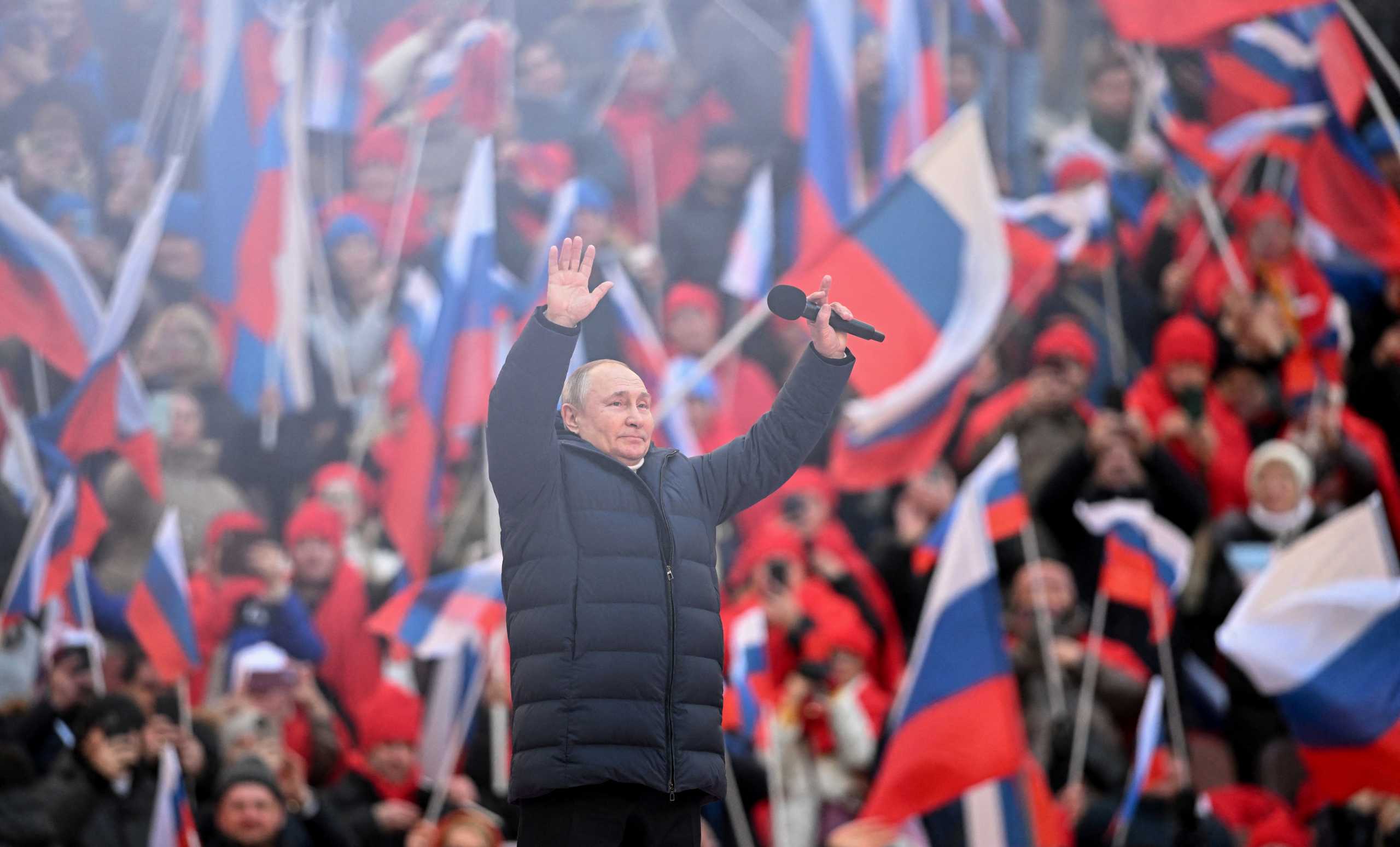 Russian President Vladimir Putin waves during a concert marking the eighth anniversary of Russia's annexation of Crimea at Luzhniki Stadium in Moscow, Russia March 18, 2022. RIA Novosti Host Photo Agency