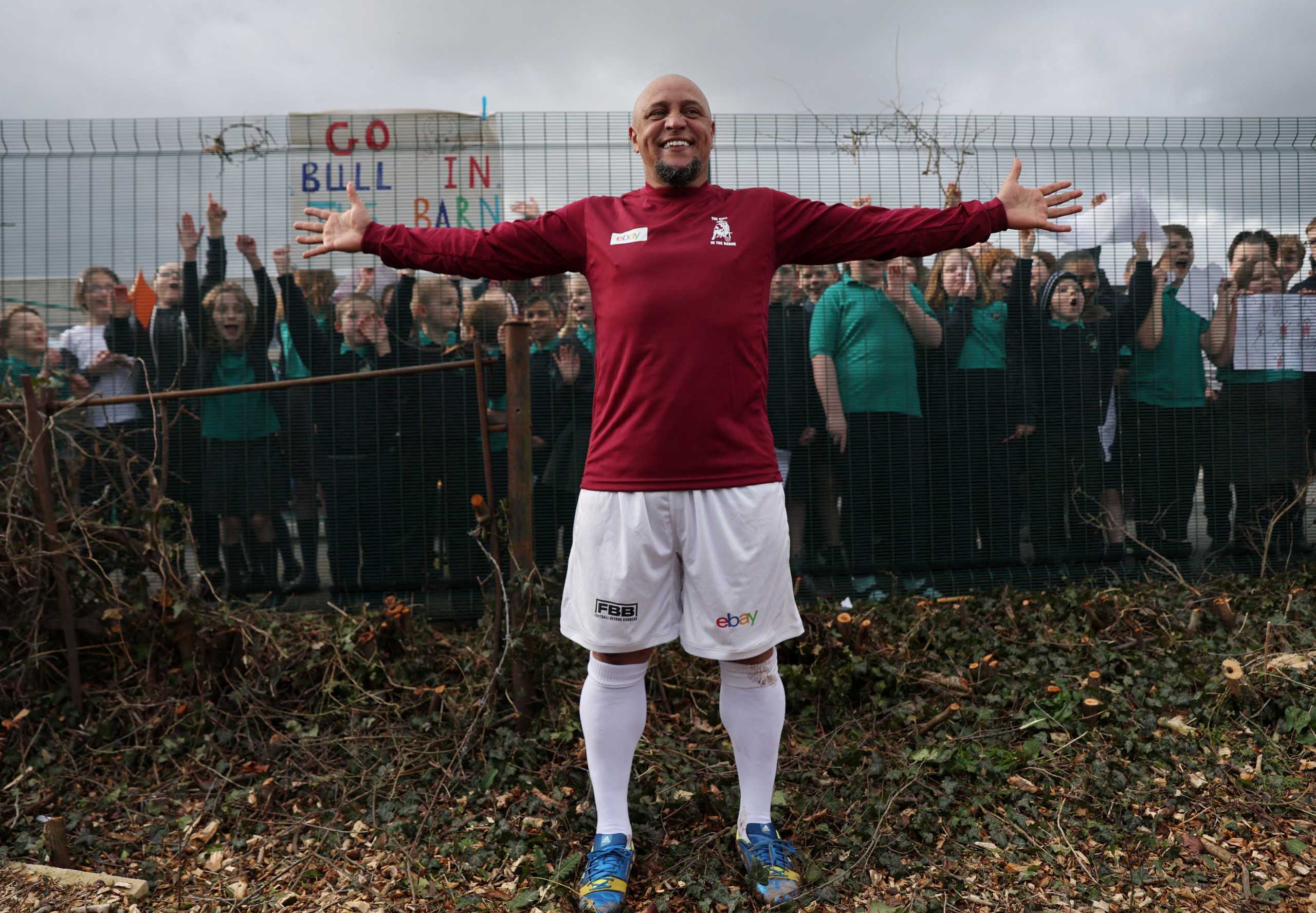 Soccer Football - Greenhous Shrewsbury and District Sunday League Division 1 - Roberto Carlos plays for Bull in the Barne United v Harlescott Rangers - Hanwood Village Hall Recreation Centre, Shrewsbury, Britain - March 4, 2022 Bull in the Barne United's Roberto Carlos poses for a photograph with local school children after the match Action Images via Reuters