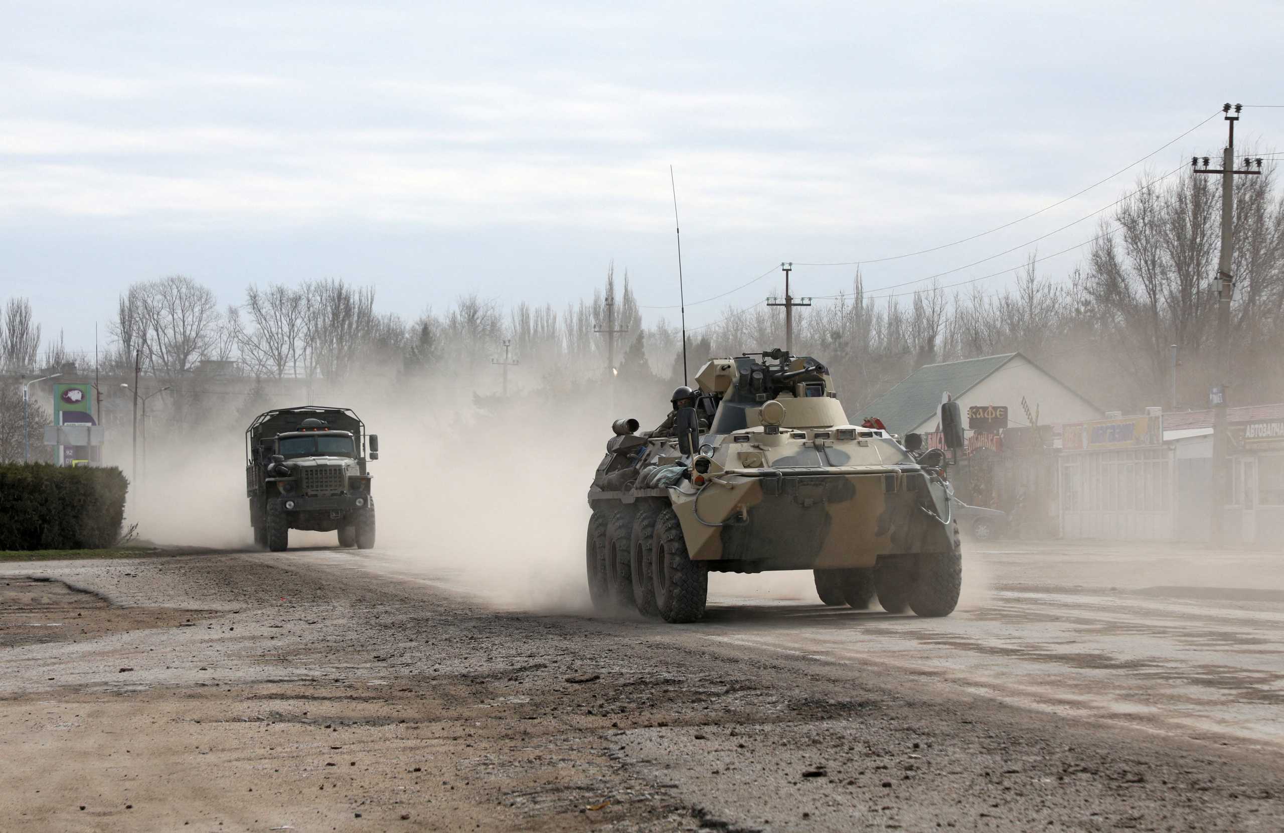 Russian Army military vehicles drive along a street, after Russian President Vladimir Putin authorized a military operation in eastern Ukraine, in the town of Armyansk, Crimea, February 24, 2022. REUTERS
