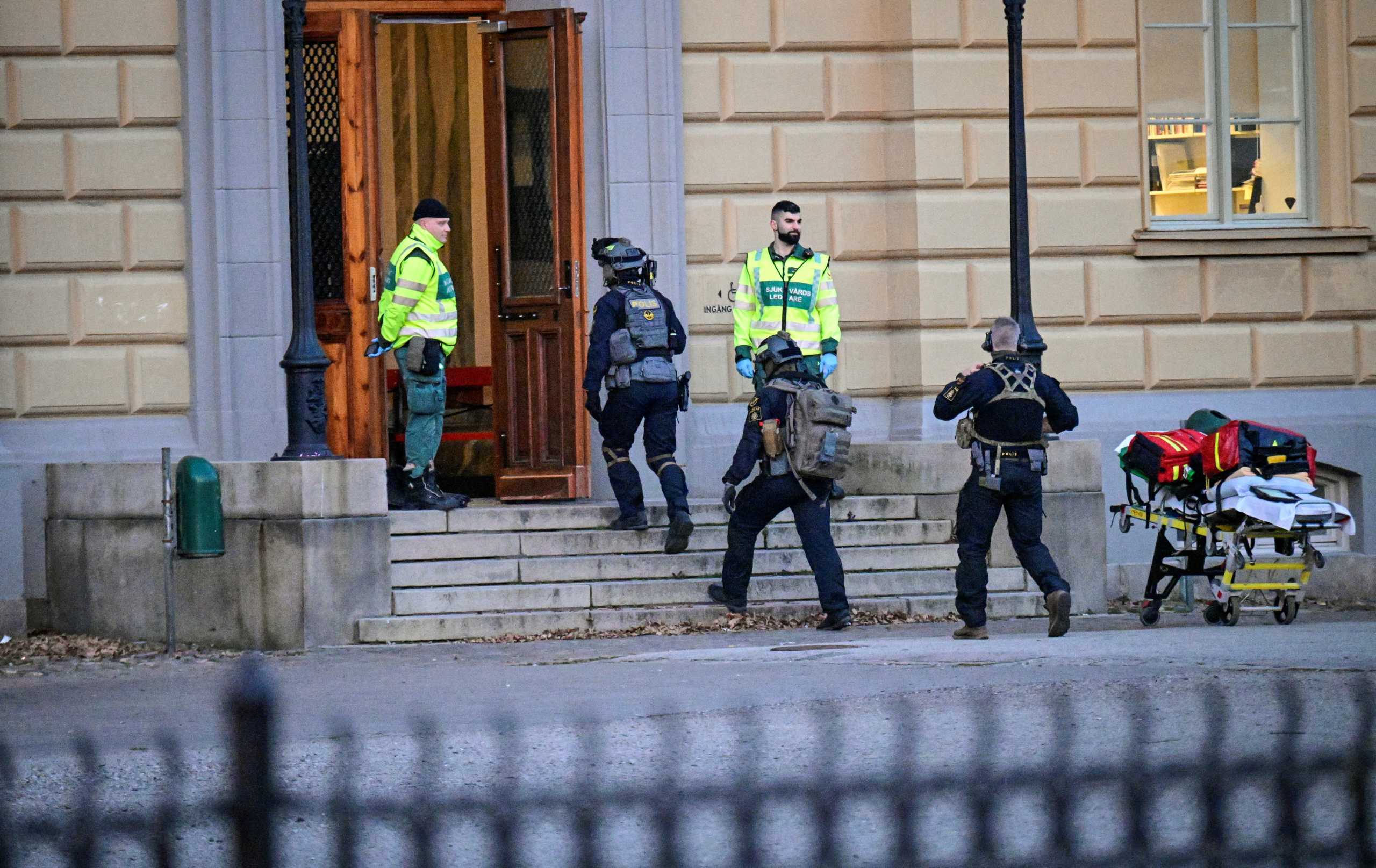 Police officers walk at the scene of a crime by a school in Malmo, Sweden March 21, 2022. TT News Agency