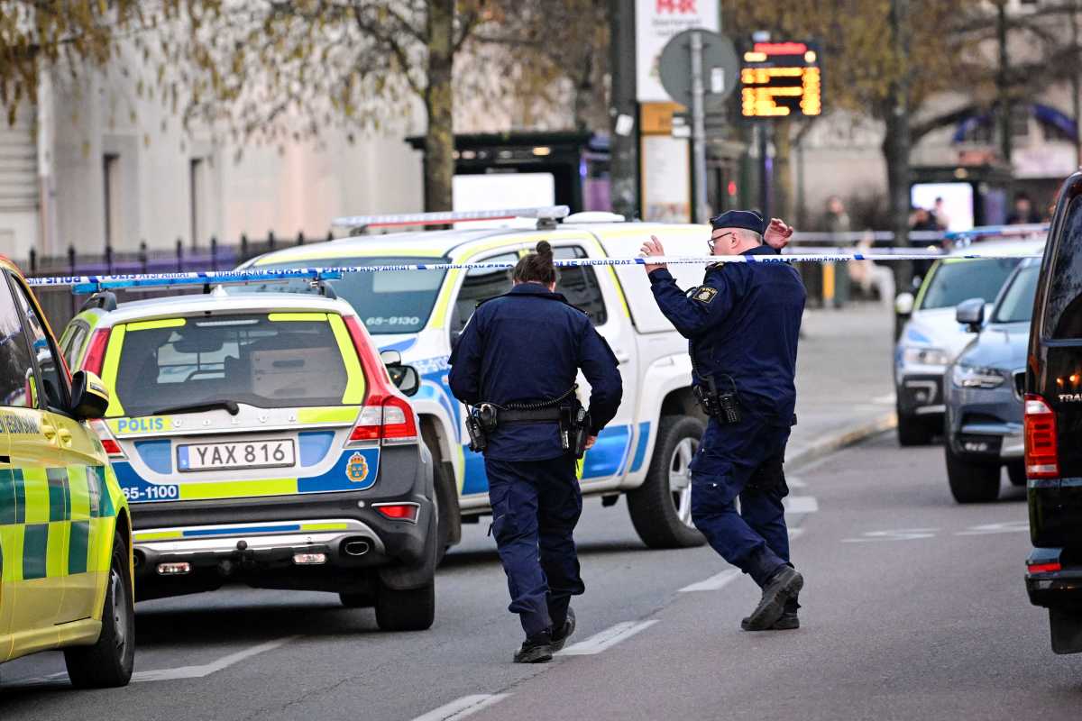 Police officers walk at the scene of a crime by a school in Malmo, Sweden March 21, 2022. TT News Agency