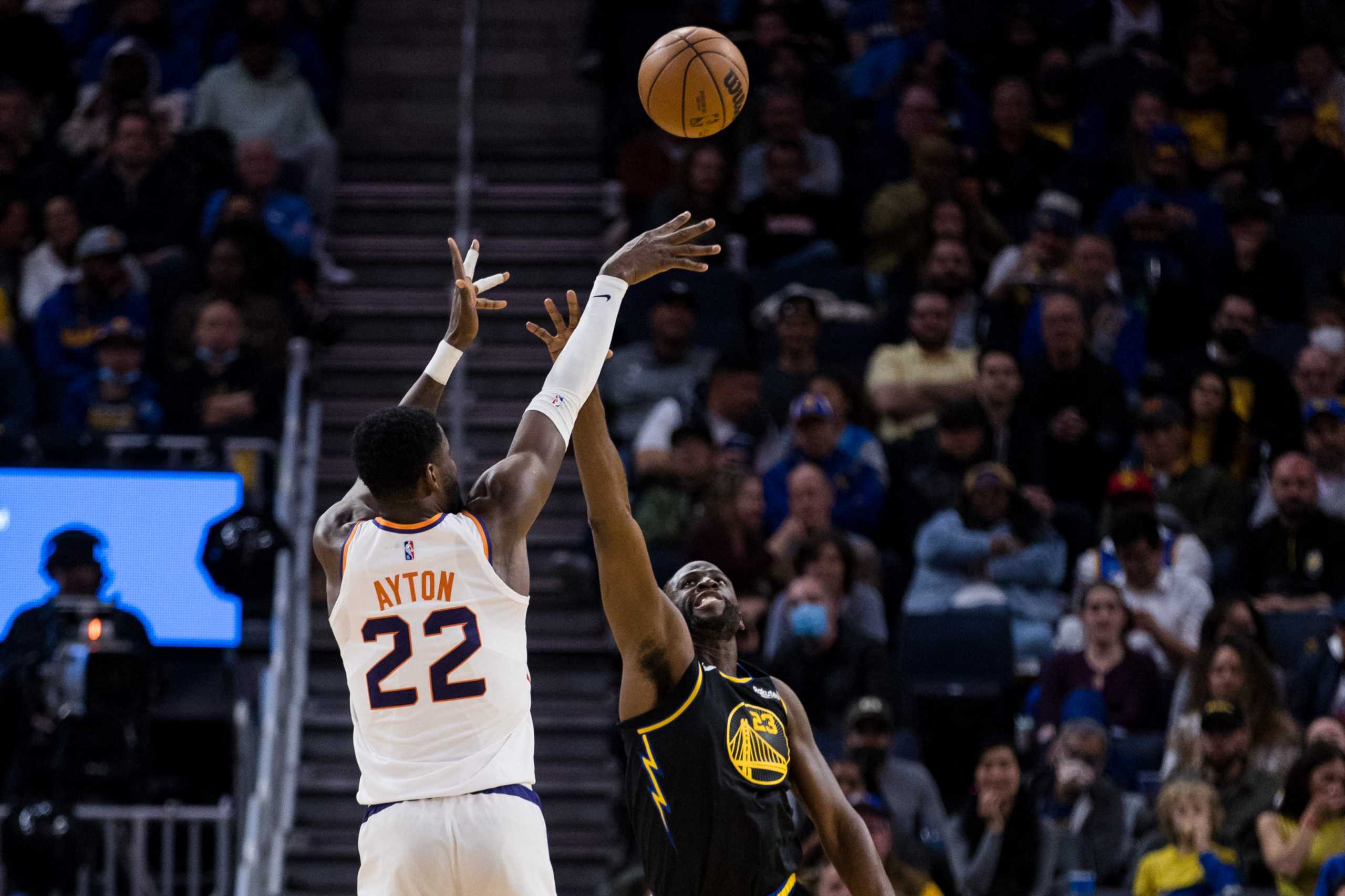 Mar 30, 2022; San Francisco, California, USA; Phoenix Suns center Deandre Ayton (22) shoots over Golden State Warriors forward Draymond Green (23) during the first half at Chase Center. Mandatory Credit: John Hefti-USA TODAY Sports