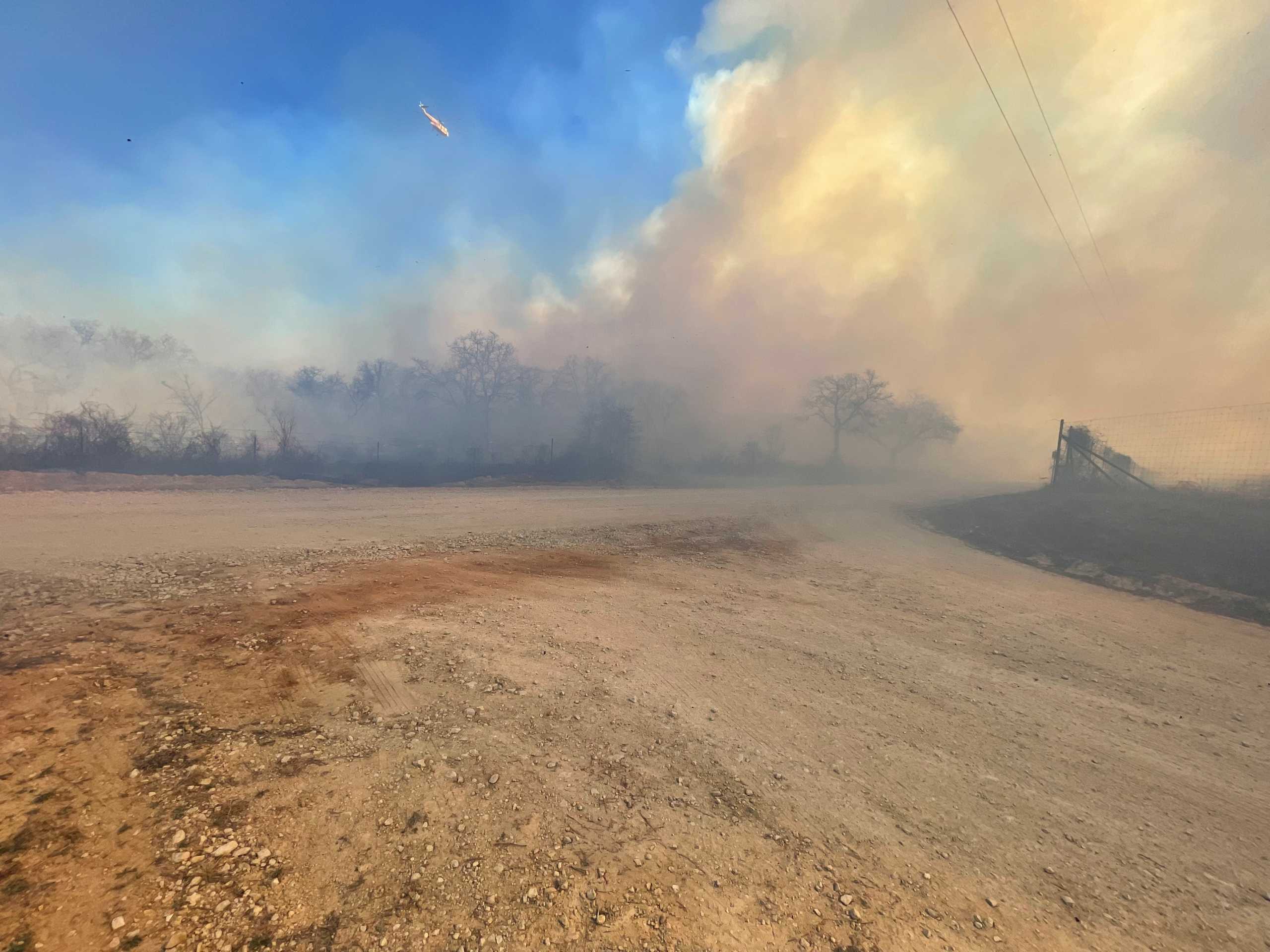 Smoke rises as the Eastland Complex wildfire burns near Rising Star, Eastland County, Texas, U.S. March 18, 2022 in this picture obtained from social media. Picture taken March 18, 2022. Twitter