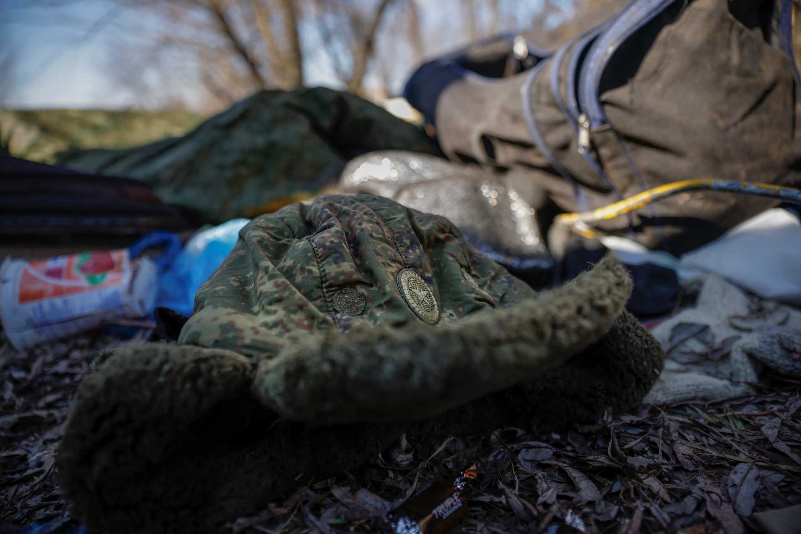 A Russian military winter hat lies among belongings Russian soldiers left behind after Ukrainian forces routed their armoured vehicles, as Russia's attack on Ukraine continues, outside Brovary, near Kyiv, Ukraine, March 10, 2022. REUTERS