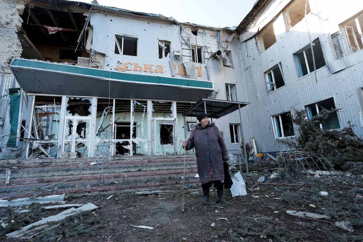A woman stands outside a local hospital, which was destroyed during Ukraine-Russia conflict in the separatist-controlled town of Volnovakha in the Donetsk region, Ukraine March 12, 2022. REUTERS