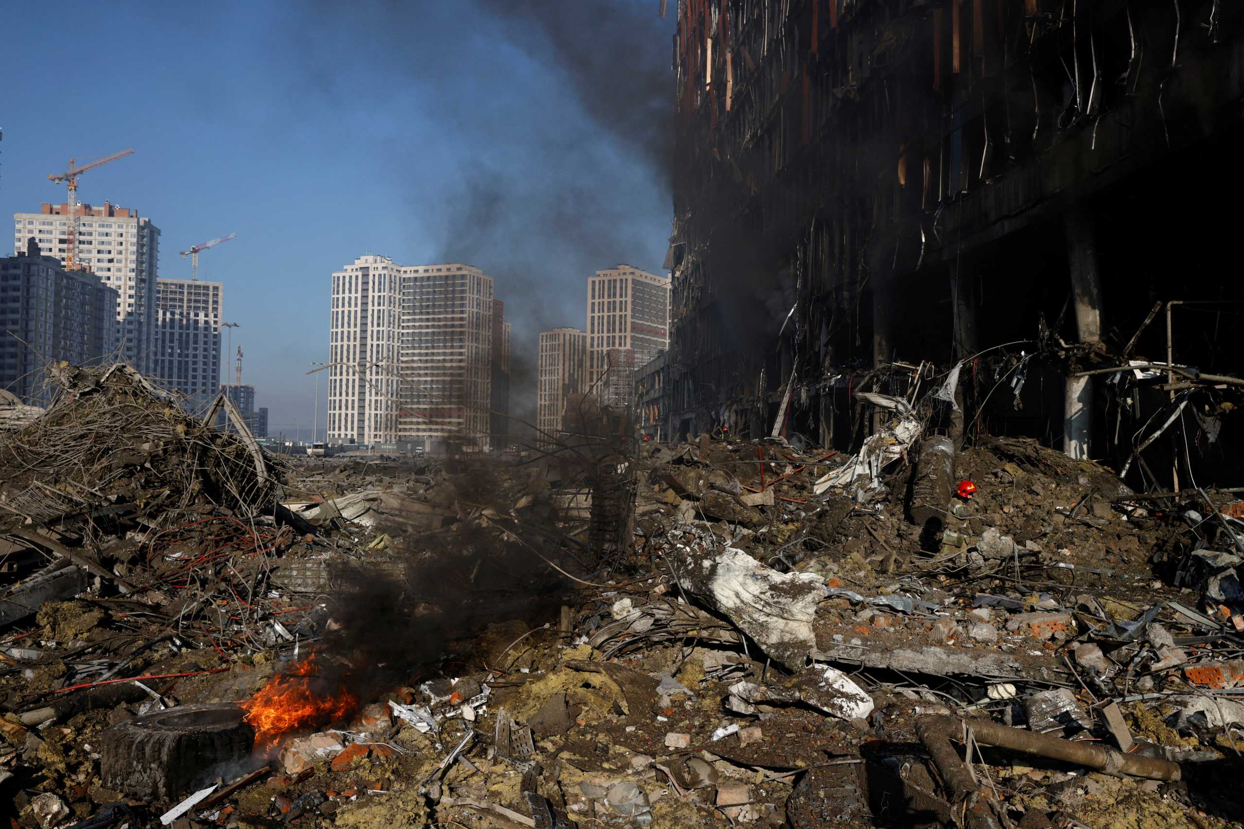 A firefighter works at the site of a bombing at a shopping center as Russia's invasion of Ukraine continues, in Kyiv, Ukraine March 21, 2022. REUTERS