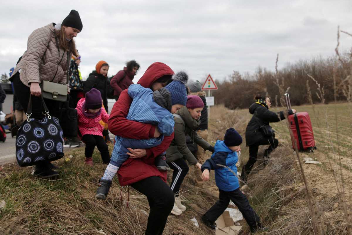 People fleeing the Russian invasion of Ukraine walk towards their transport helicopter after arriving in Slovakia, at a border crossing in Vysne Nemecke, Slovakia, March 5, 2022. REUTERS