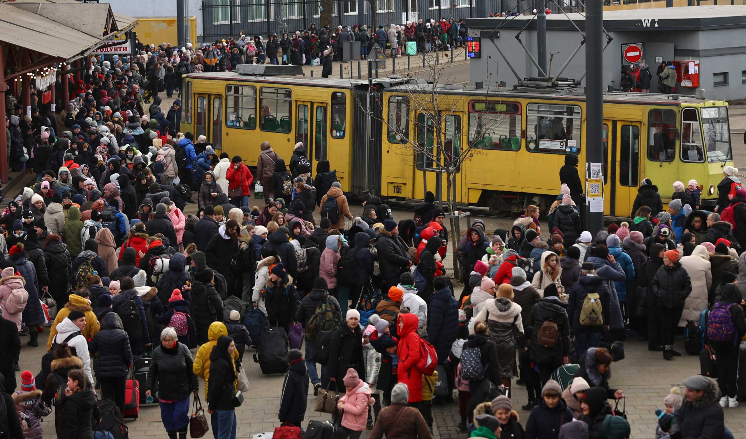 Refugees fleeing the ongoing Russian invasion of Ukraine wait for hours to board a train to Poland, outside the train station in Lviv, Ukraine, March 8, 2022. REUTERS