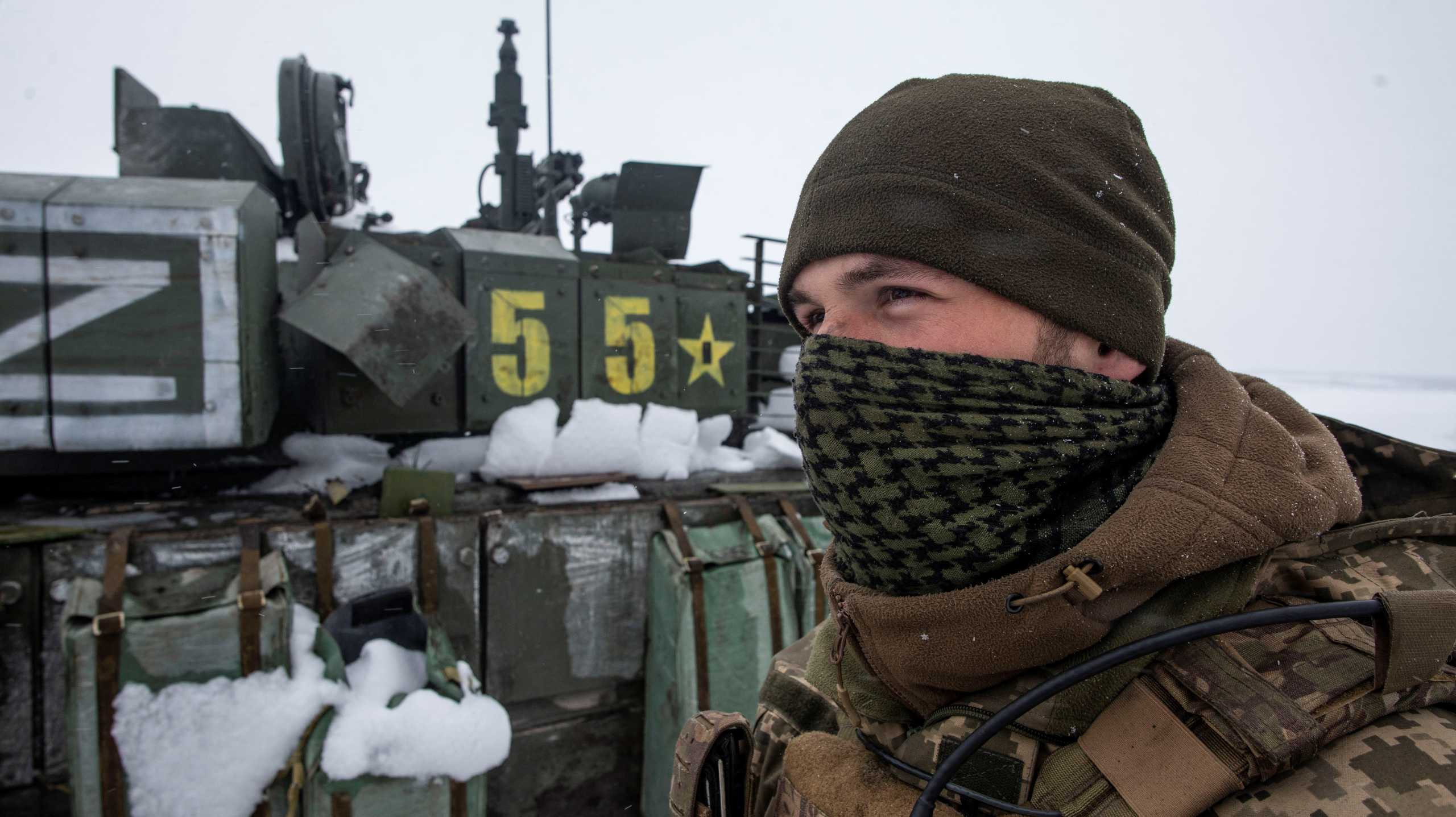 A Ukrainian serviceman stands near a captured Russian tank marked with the letter ''Z'', in the north of the Kharkiv region, Ukraine March 4, 2022. Picture taken March 4, 2022. Irina Rybakova