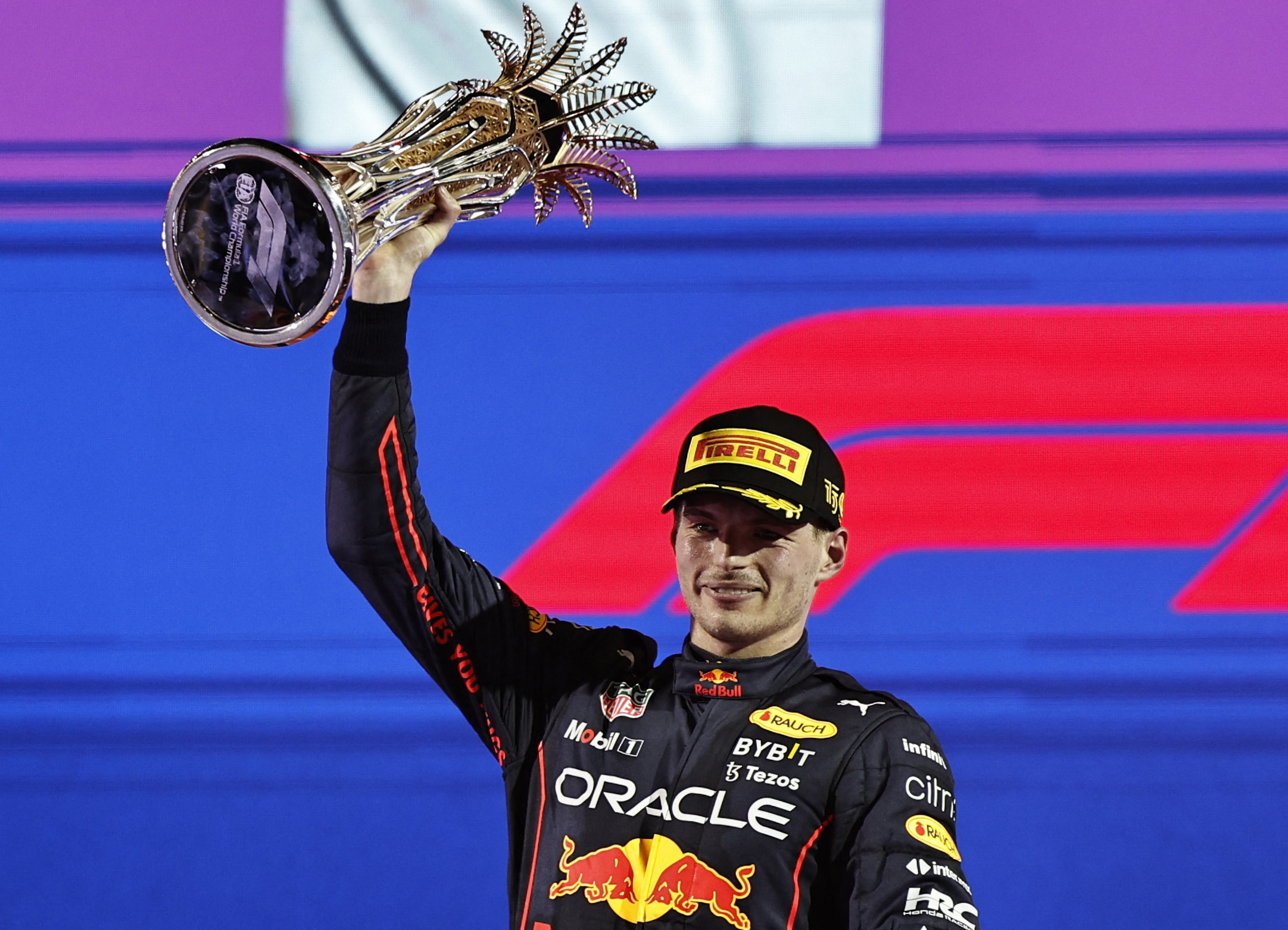 Formula One F1 - Saudi Arabia Grand Prix - Jeddah Corniche Circuit, Jeddah, Saudi Arabia - March 27, 2022 Red Bull's Max Verstappen celebrates on the podium with the trophy after winning the race REUTERS