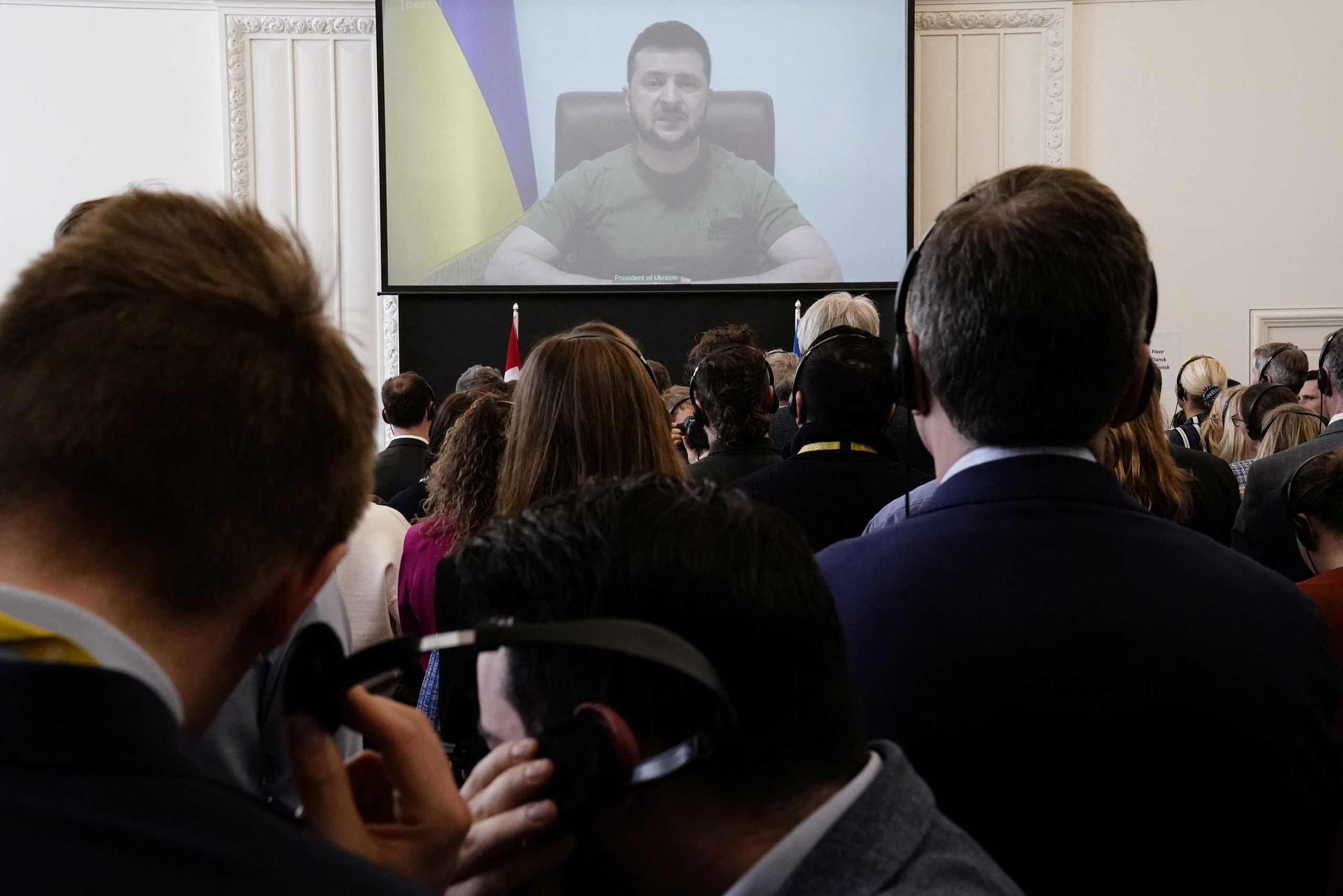 Members of the Danish Parliament attend the Ukrainian President Volodymyr Zelenskiy's speech to the Danish Parliament via video link, at the Christiansborg Castle in Copenhagen, Denmark, March 29, 2022. Mads Claus Rasmussen