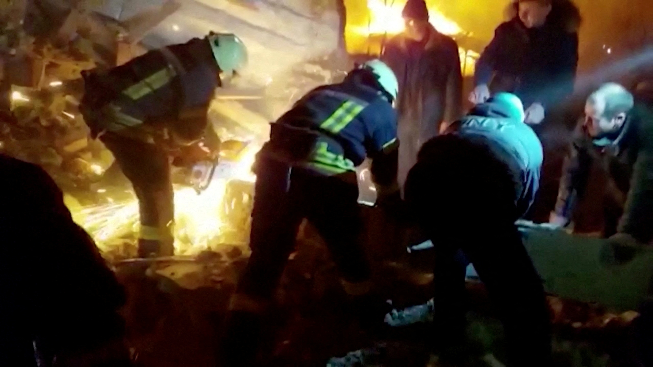 Rescuers work at the site of a Russian strike during Russia's invasion of Ukraine, in Zhytomyr, Ukraine, March 1, 2022 in this still image taken from video.  State Emergency Service of Ukraine