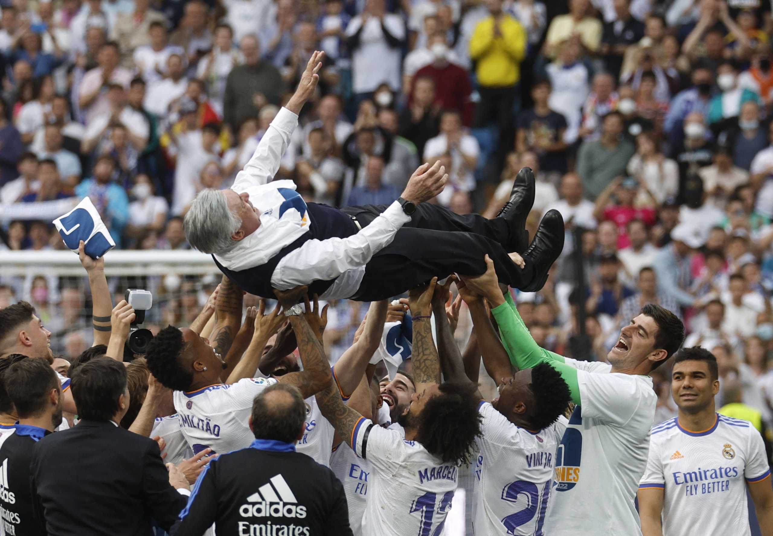 Soccer Football - LaLiga - Real Madrid v Espanyol - Santiago Bernabeu, Madrid, Spain - April 30, 2022 Real Madrid team members lift coach Carlo Ancelotti in the air and celebrate after winning LaLiga REUTERS