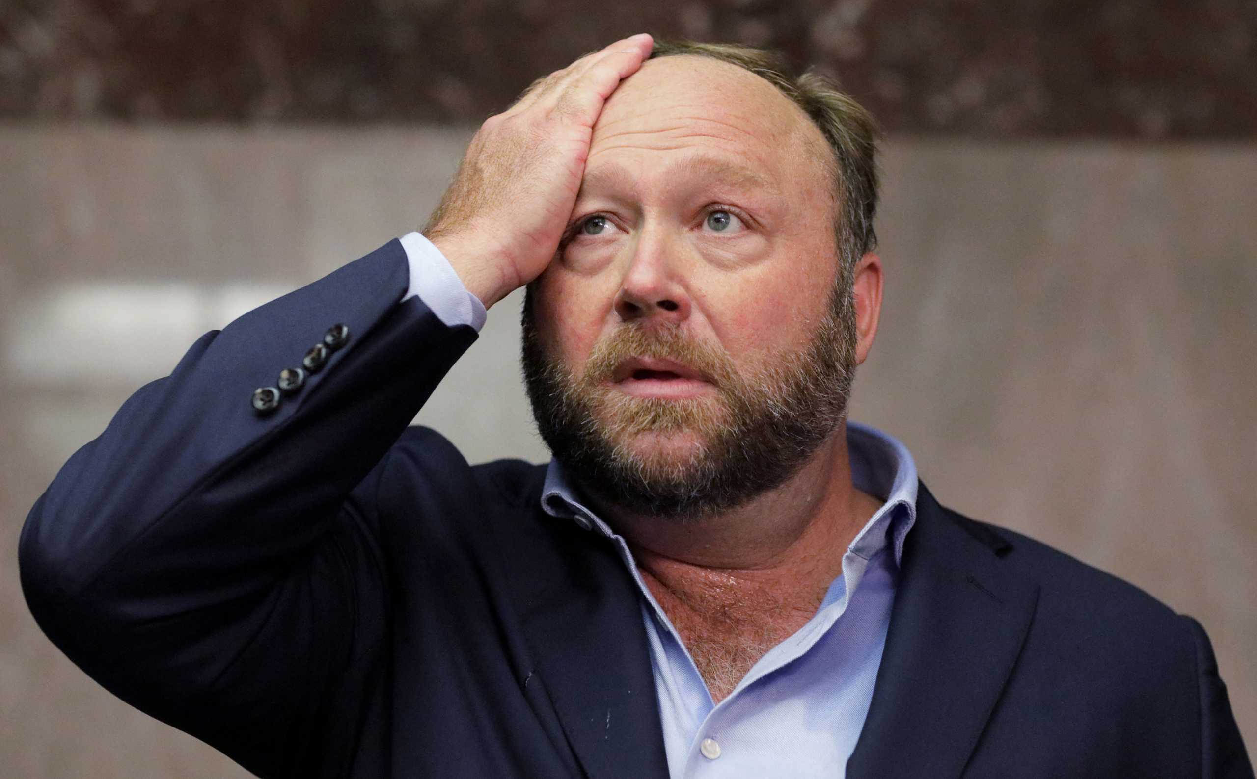 FILE PHOTO: Alex Jones of Infowars talks to the media while visiting the U.S. Senate's Dirksen Senate office building as Twitter CEO Jack Dorsey testifies before a Senate Intelligence Committee hearing on Capitol Hill in Washington, U.S., September 5, 2018.  Picture taken September 5, 2018. REUTERS