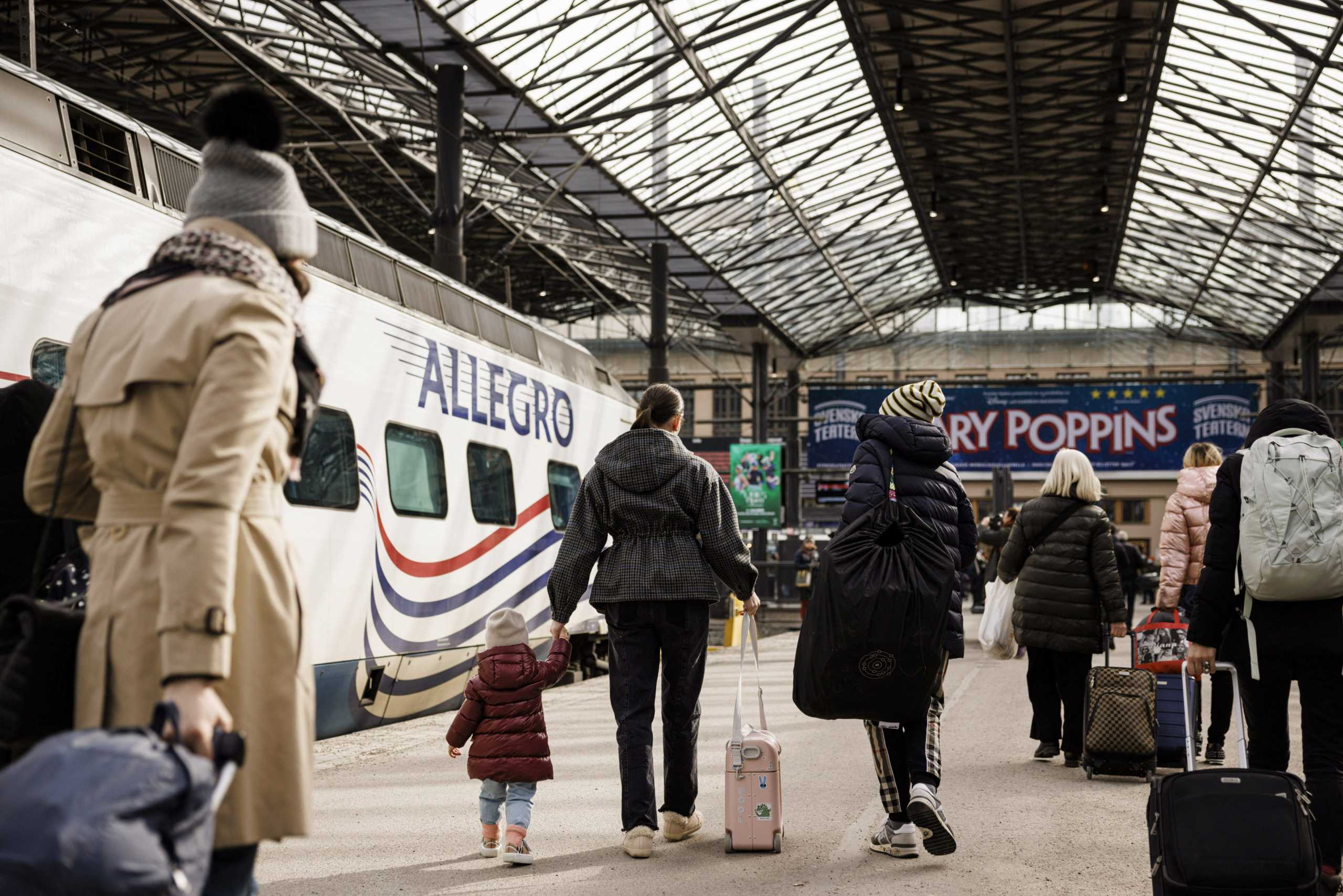 Passengers of the second last Allegro train from St Petersburg, Russia, walk at the railway station on Sunday afternoon in Helsinki, Finland March 27, 2022. Allegro train service between Helsinki and St Petersburg will be temporarily discontinued from Monday, March 28, in light of sanctions imposed on Russia after its invasion of Ukraine. Lehtikuva