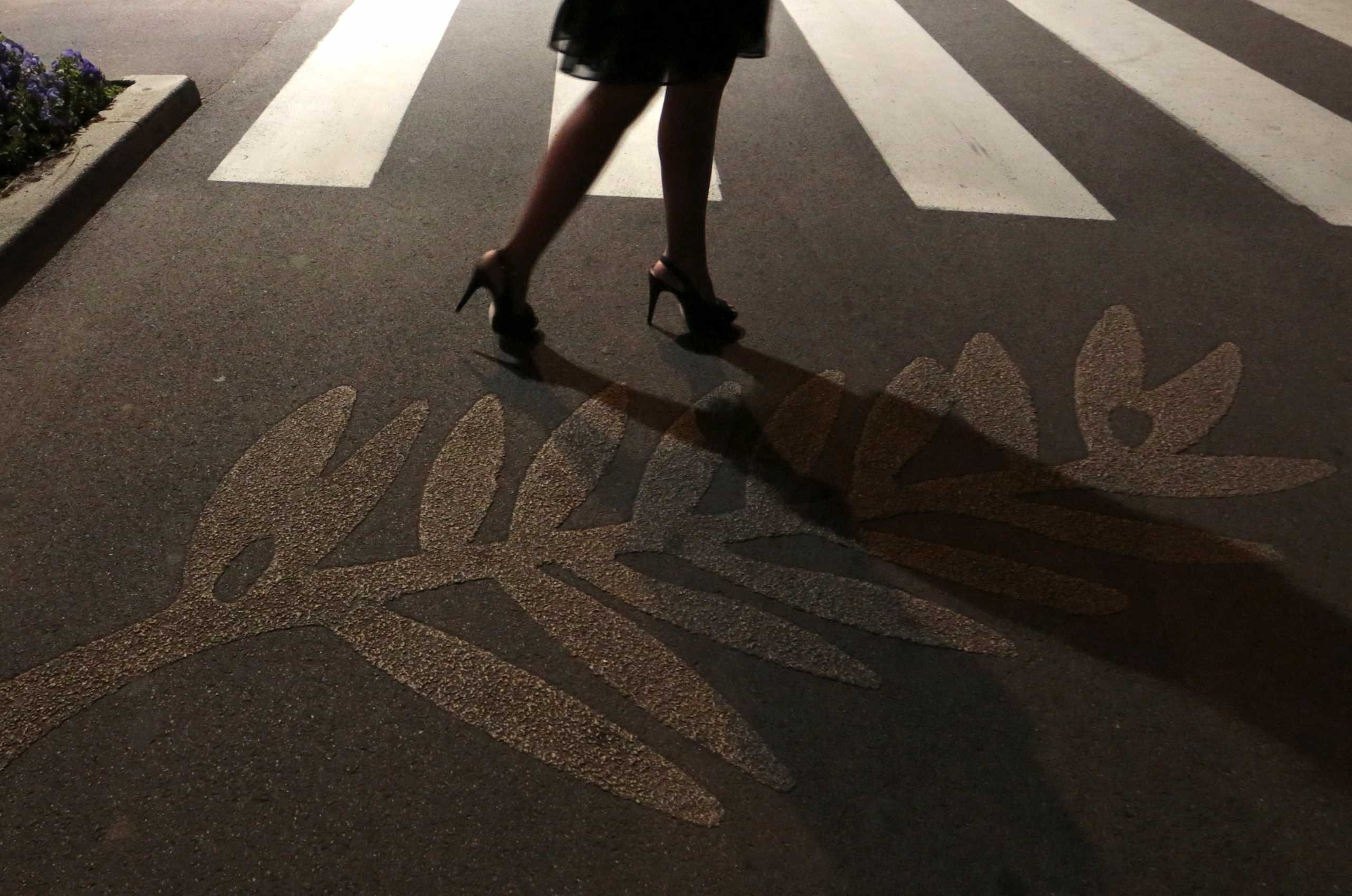 A woman walks past Palme d'Or symbols on the pavement along the Croisette during the 66th Cannes Film Festival in Cannes May 17, 2013.             REUTERS