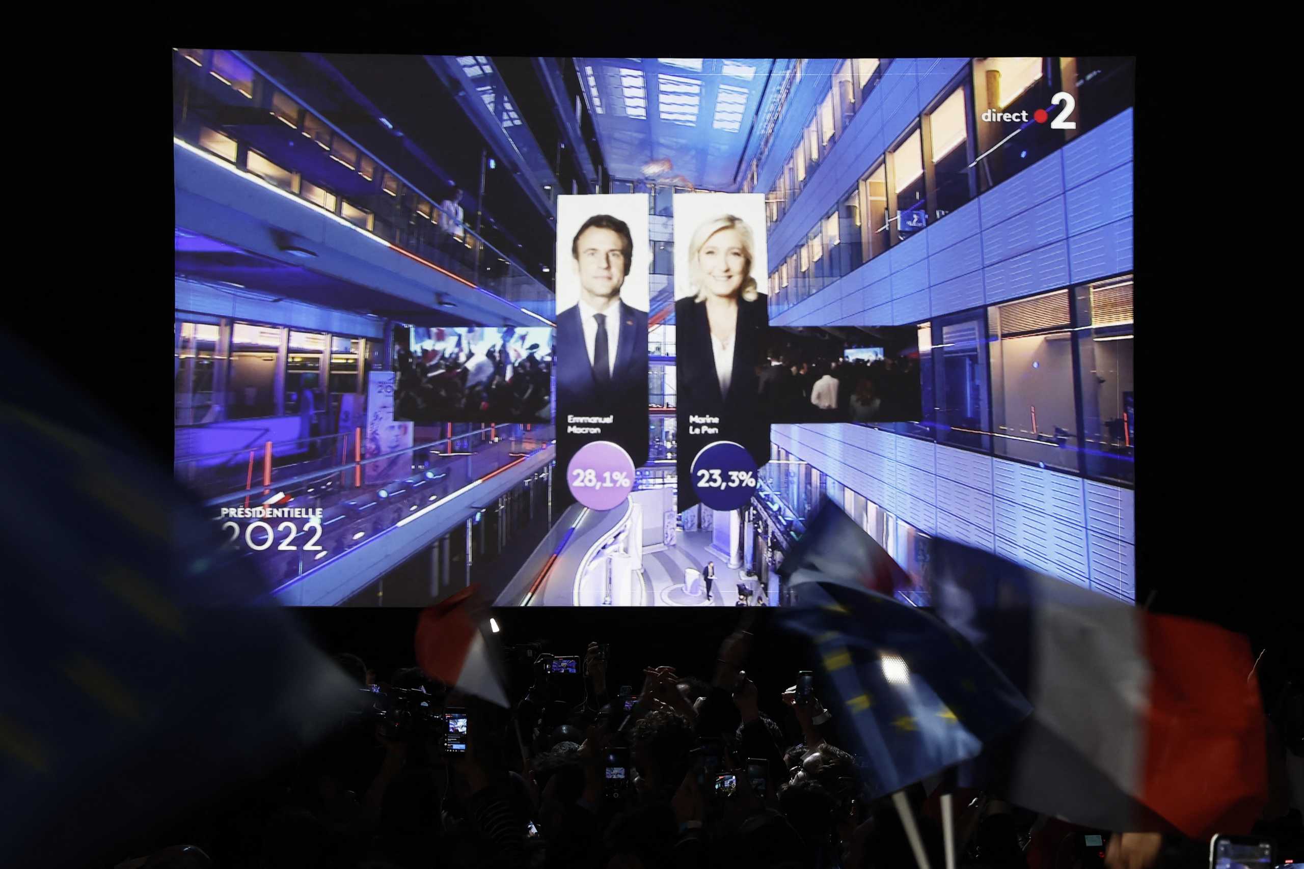Supporters of French President Emmanuel Macron, candidate for his re-election, react after early results in the first round of the 2022 French presidential election, in Paris, France April 10, 2022. REUTERS