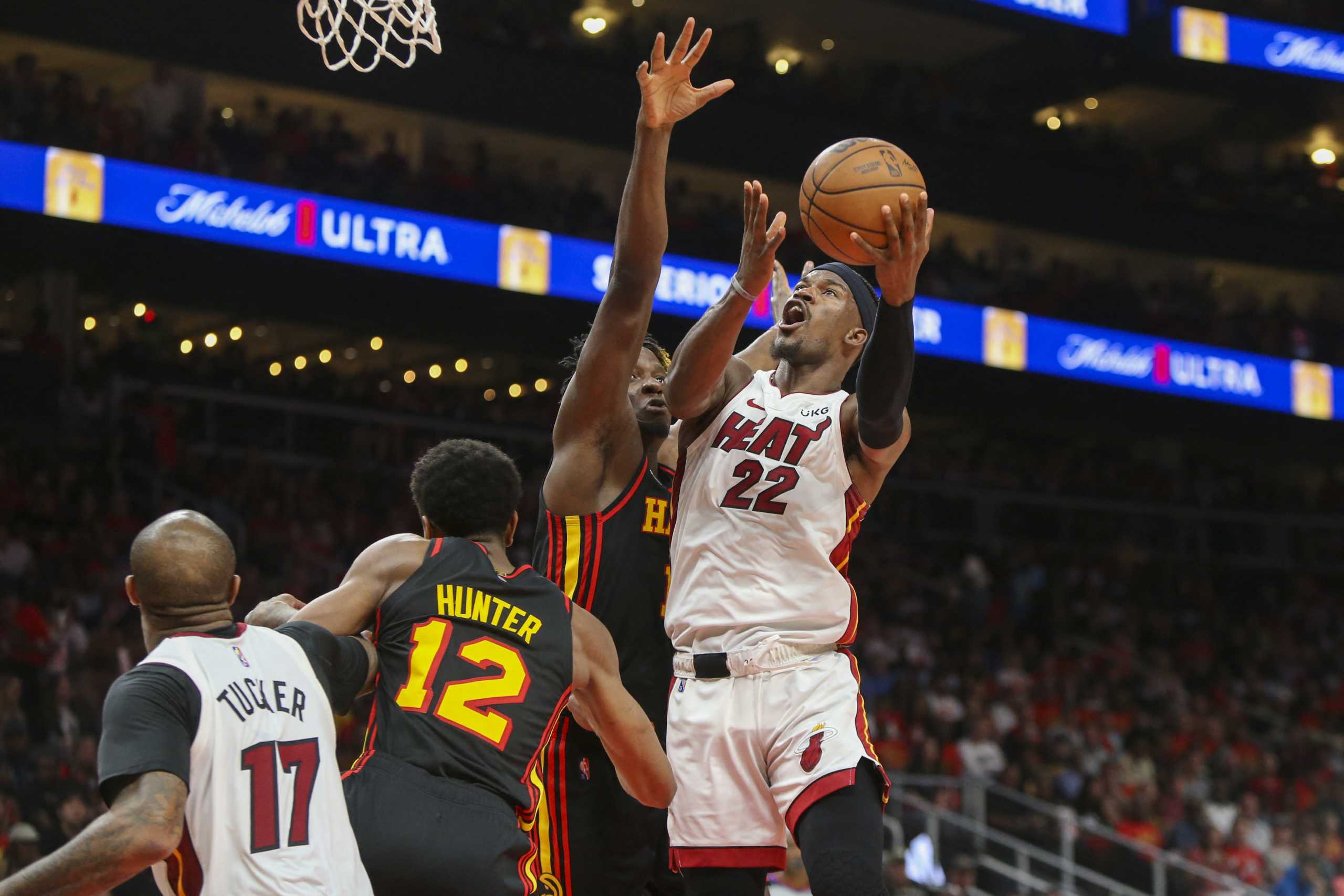 Apr 24, 2022; Atlanta, Georgia, USA; Miami Heat forward Jimmy Butler (22) shoots past Atlanta Hawks center Clint Capela (15) in the second quarter during game four of the first round of the 2022 NBA playoffs at State Farm Arena. Mandatory Credit: Brett Davis-USA TODAY Sports