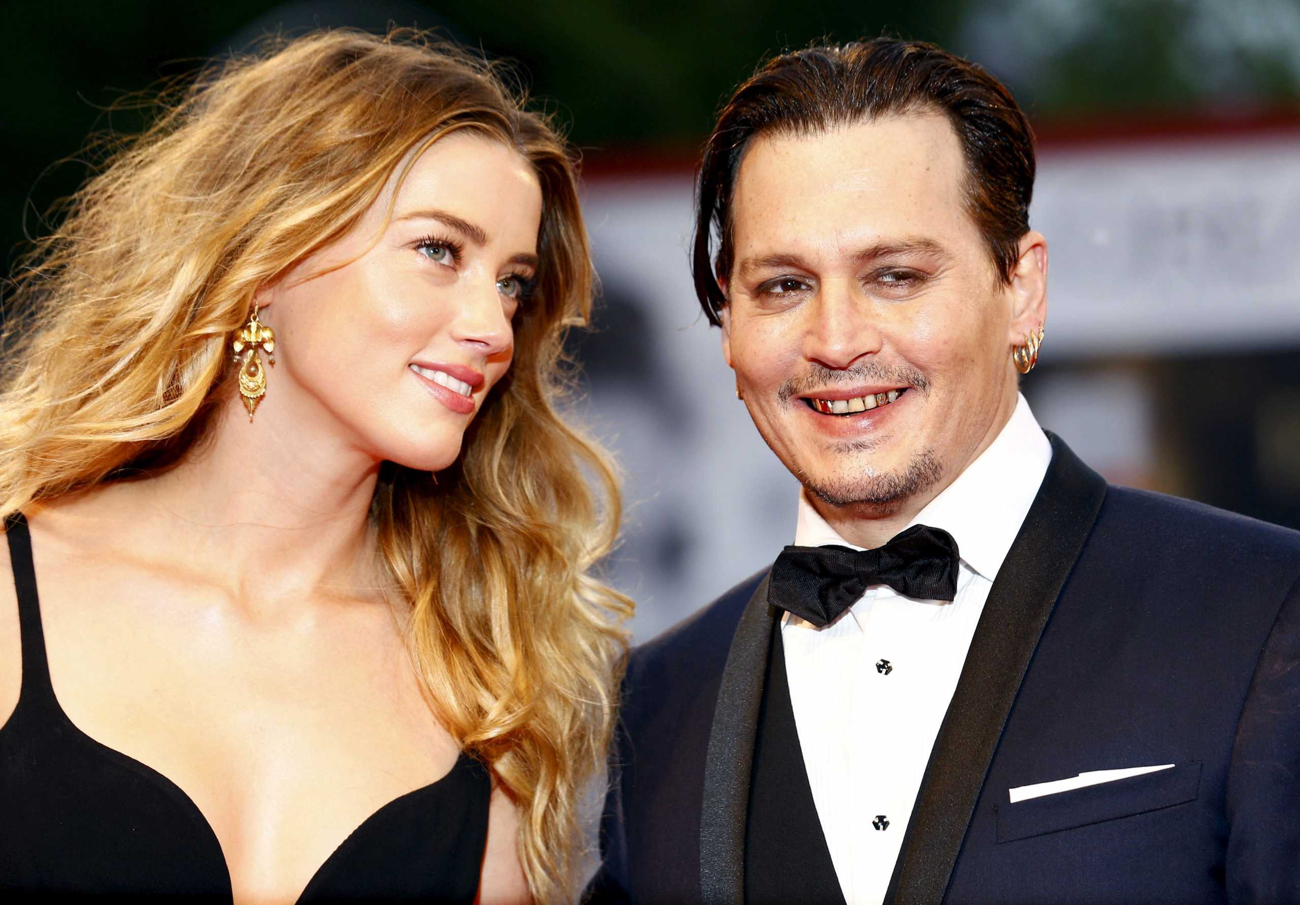 Actor Johnny Depp (R) and his wife Amber Heard (L) attend the red carpet event for the movie "Black Mass" at the 72nd Venice Film Festival in northern Italy September 4, 2015. REUTERS