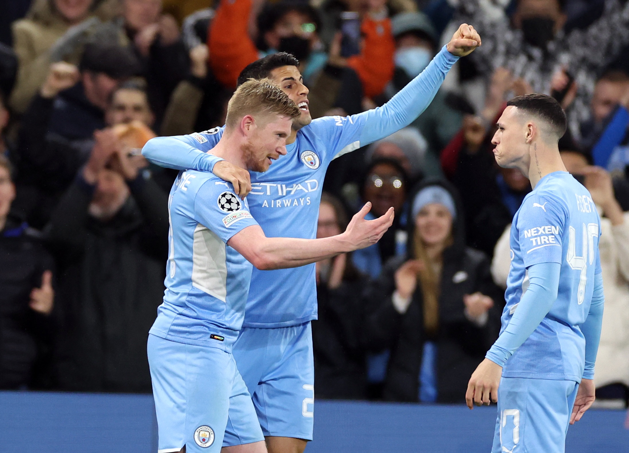 Soccer Football - Champions League - Quarter-Final - First Leg - Manchester City v Atletico Madrid - Etihad Stadium, Manchester, Britain - April 5, 2022 Manchester City's Kevin De Bruyne celebrates scoring their first goal with Joao Cancelo and Phil Foden REUTERS