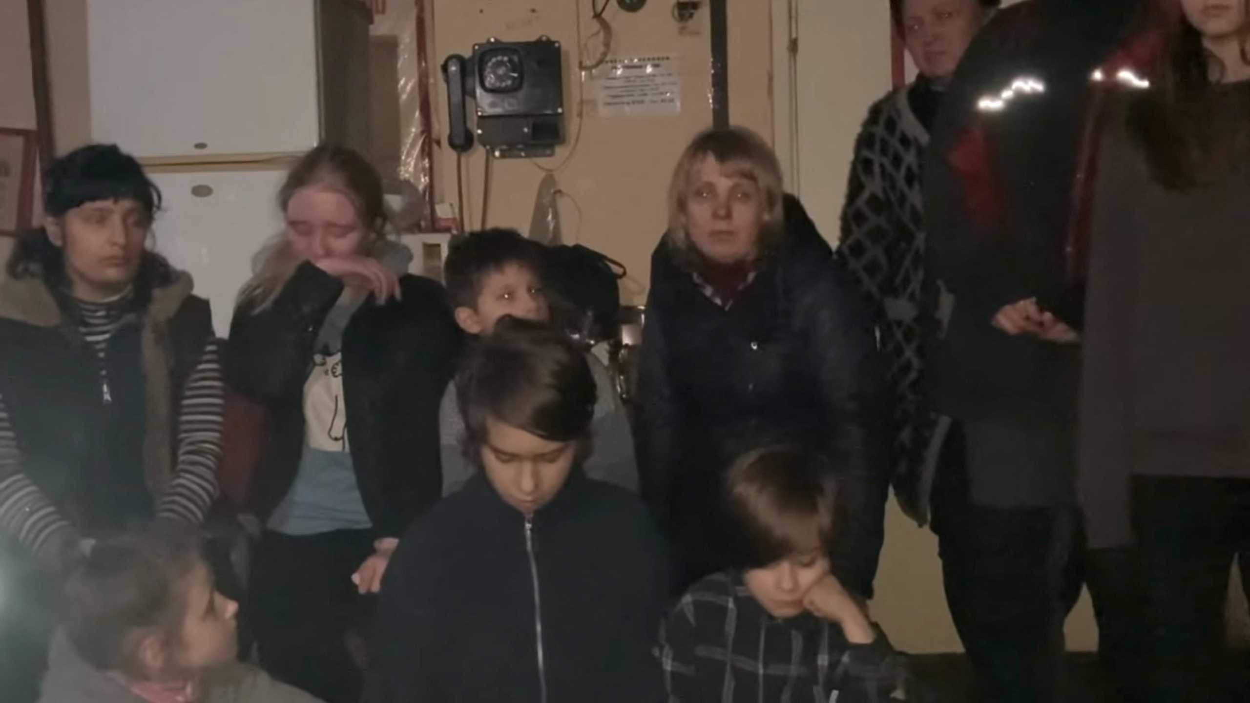 Civilians react as they gather on Orthodox Easter Sunday in this handout image at the Azovstal steel plant where Ukrainian soldiers are holding out and civilians sheltering, amid Russia's siege of the city, during its invasion, in Mariupol, Ukraine April 24, 2022. Azov