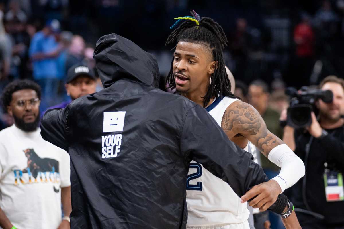 Apr 21, 2022; Minneapolis, Minnesota, USA; Memphis Grizzlies guard Ja Morant (12) hugs his dad after the game against the Minnesota Timberwolves during game one of the three round for the 2022 NBA playoffs at Target Center. Mandatory Credit: Brad Rempel-USA TODAY Sports
