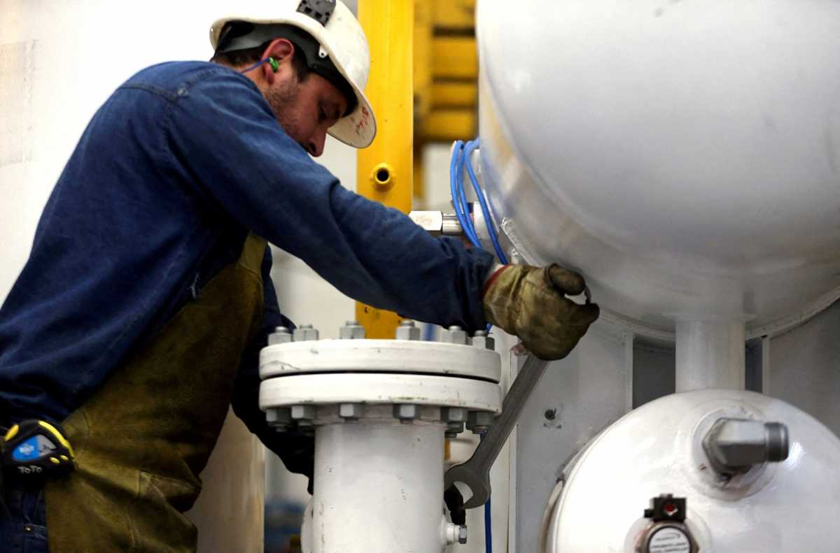FILE PHOTO: An employee works on a compressed natural gas storage module at the Galileo Technologies plant in Villa Raffo, on the outskirts of Buenos Aires, Argentina October 24, 2017. Picture taken October 24, 2017. REUTERS