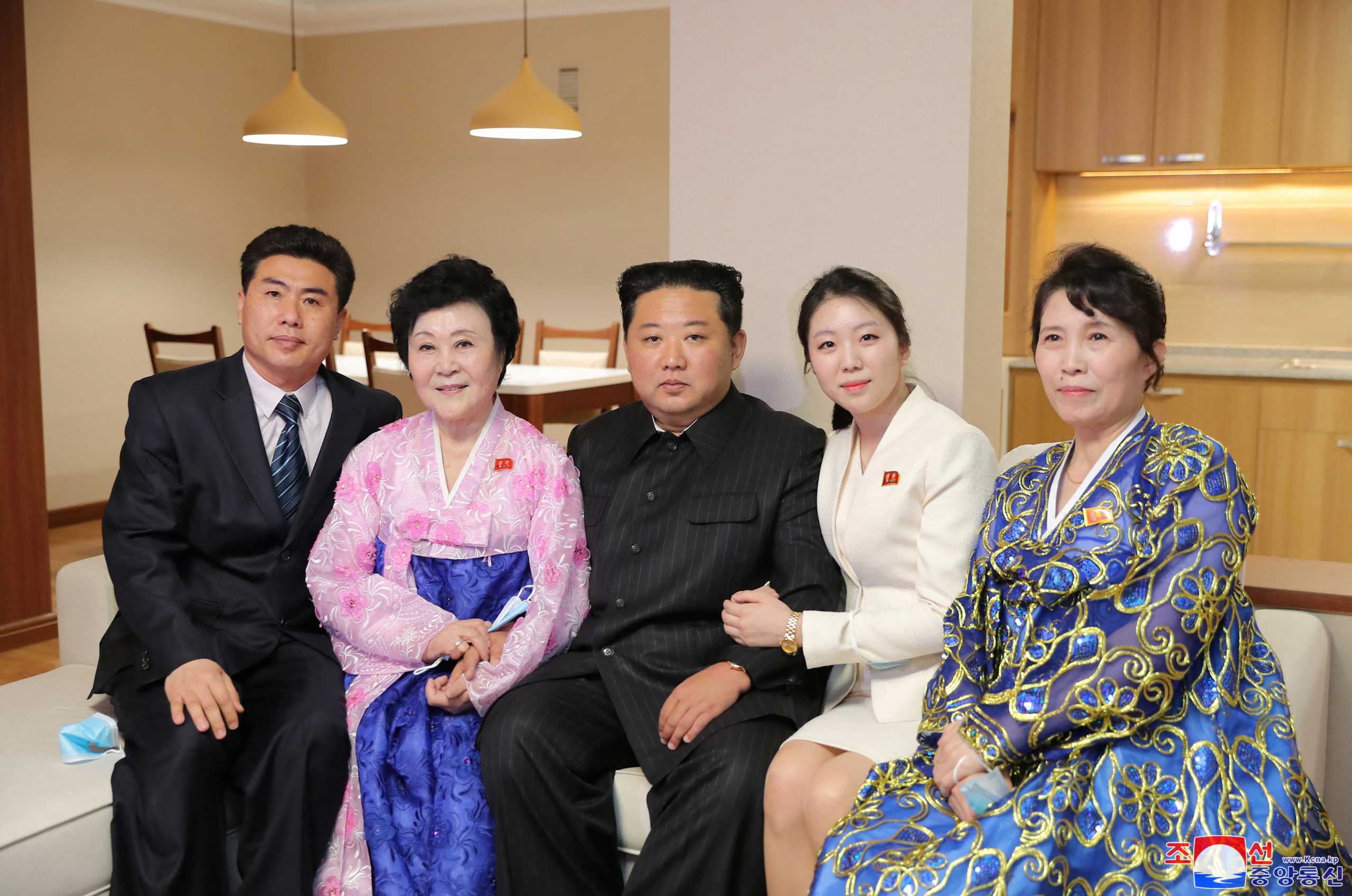 North Korean leader Kim Jong Un poses with North Korean announcer Ri Chun-hee and her family at a house in a terraced residential district on a bank of the Pothong River during the completion ceremony, in Pyongyang, North Korea, April 13, 2022. Picture taken April 13, 2022 by North Korea's Korean Central News Agency (KCNA). KCNA via REUTERS ATTENTION EDITORS - THIS IMAGE WAS PROVIDED BY A THIRD PARTY. REUTERS IS UNABLE TO INDEPENDENTLY VERIFY THIS IMAGE. NO THIRD PARTY SALES. SOUTH KOREA OUT. NO COMMERCIAL OR EDITORIAL SALES IN SOUTH KOREA.