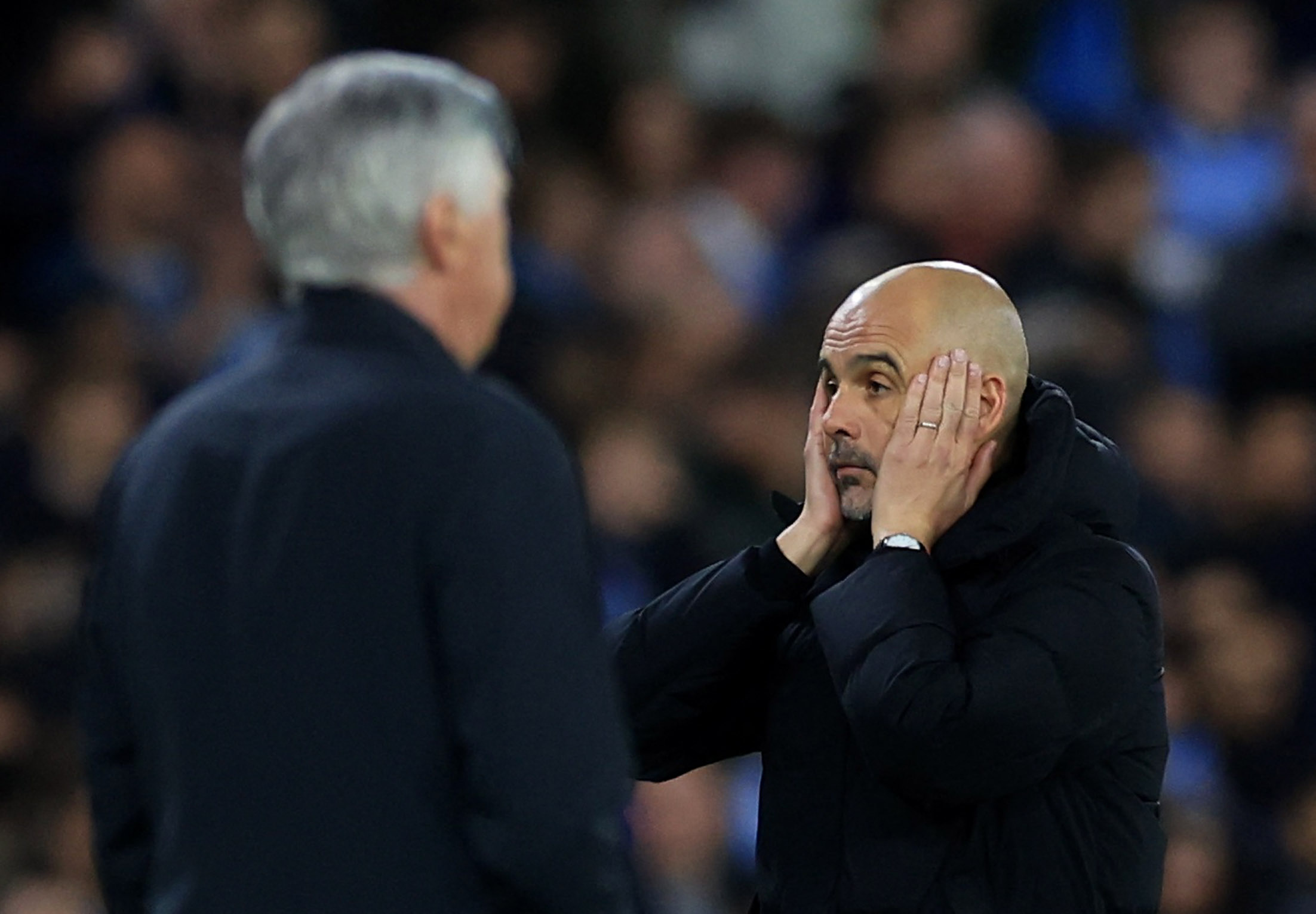 Soccer Football - Champions League - Semi Final - First Leg - Manchester City v Real Madrid - Etihad Stadium, Manchester, Britain - April 26, 2022 Manchester City manager Pep Guardiola reacts as Real Madrid coach Carlo Ancelotti looks on Action Images via Reuters