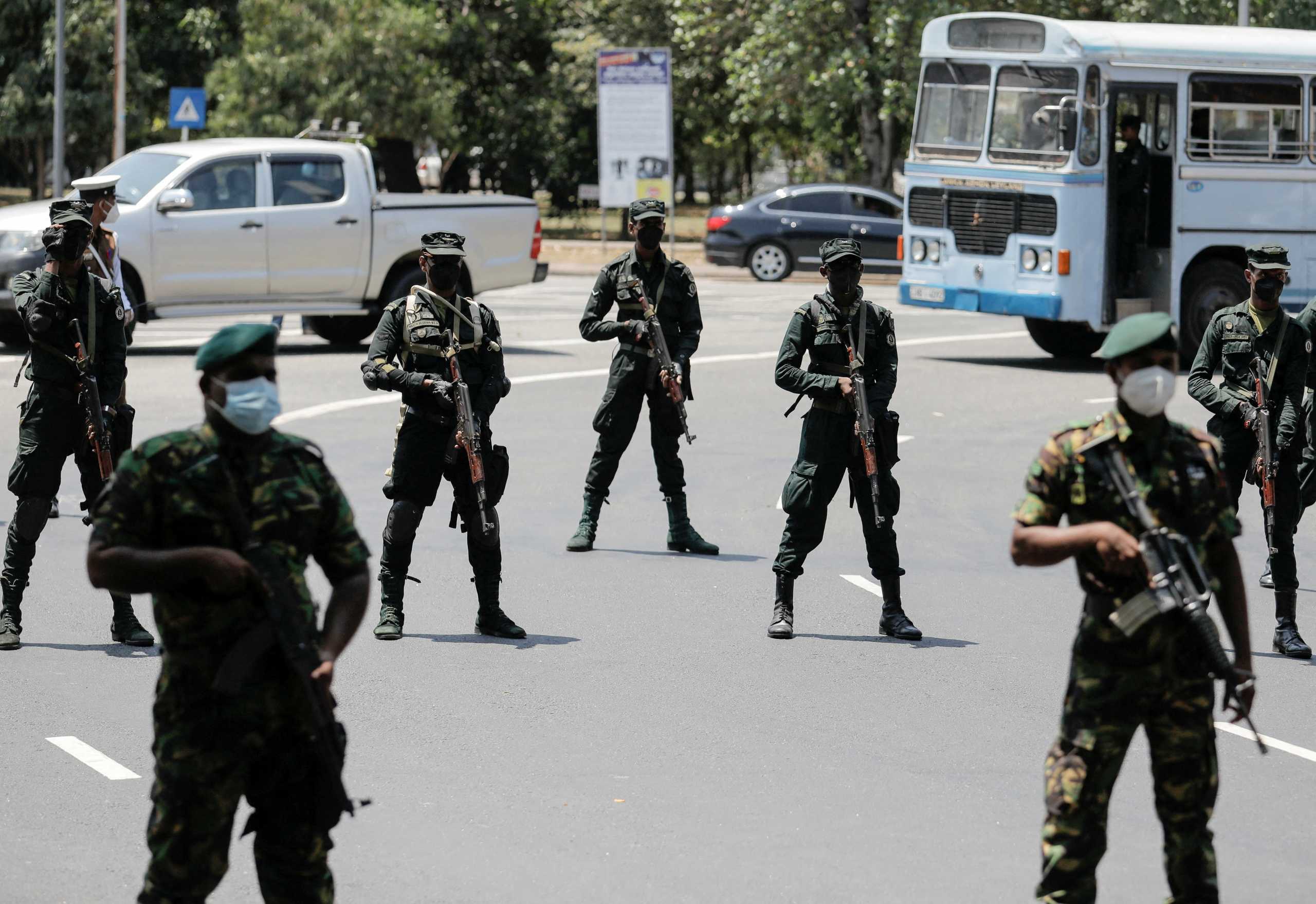 Sri Lankan army soldiers stand guard near the Independence Square as opposition alliance Samagi Jana Balawegaya party members protest against President Gotabaya Rajapaksa in Colombo, Sri Lanka April 3, 2022. The government imposed a curfew following clashes between the police and protestors near Rajapaksa's residence during a protest last Thursday, amid the country's economic crisis. REUTERS