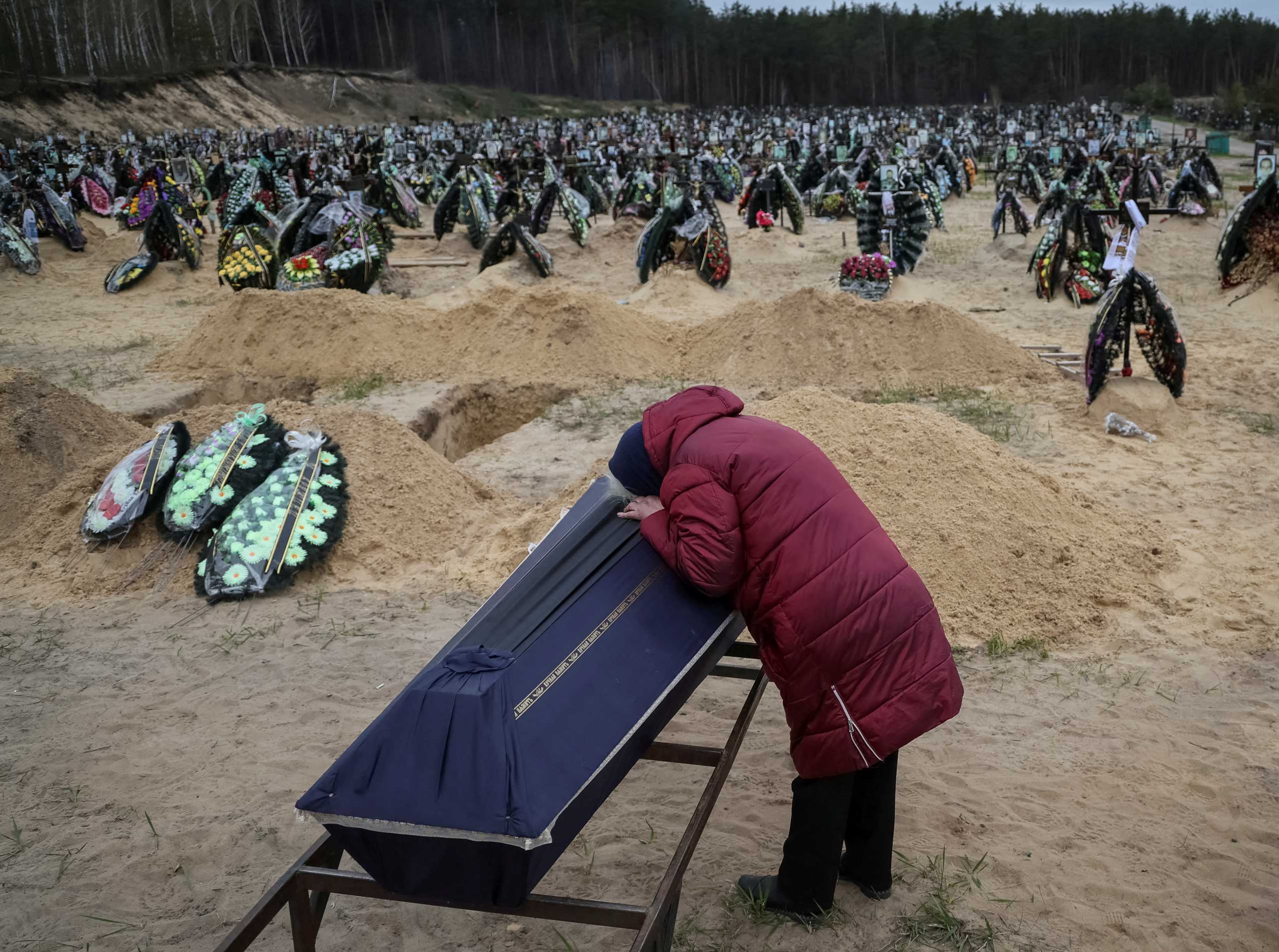 A woman reacts during a funeral of her relative, who died during the shelling by Russian troops, amid Russia's invasion of Ukraine, at the cemetery in Irpin, Kyiv region, Ukraine April 17, 2022.  REUTERS