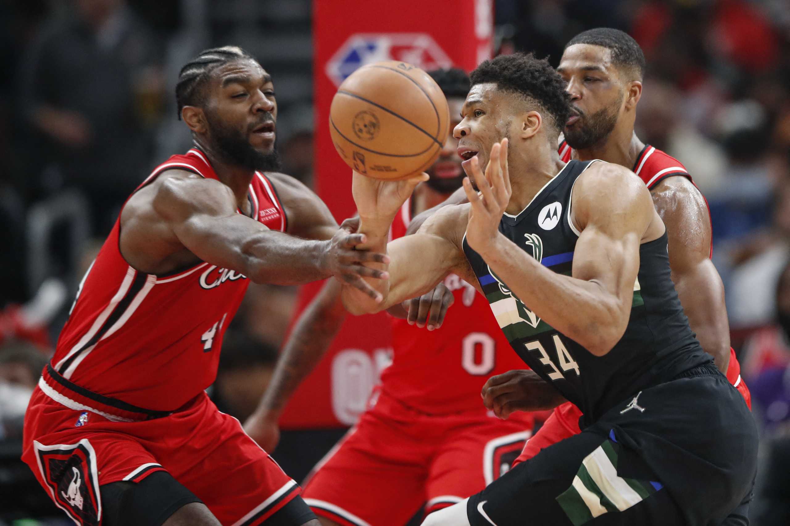 Apr 5, 2022; Chicago, Illinois, USA; Milwaukee Bucks forward Giannis Antetokounmpo (34) passes the ball as he is defended by Chicago Bulls forward Patrick Williams (44) and center Tristan Thompson (3) during the second half at United Center. Mandatory Credit: Kamil Krzaczynski-USA TODAY Sports