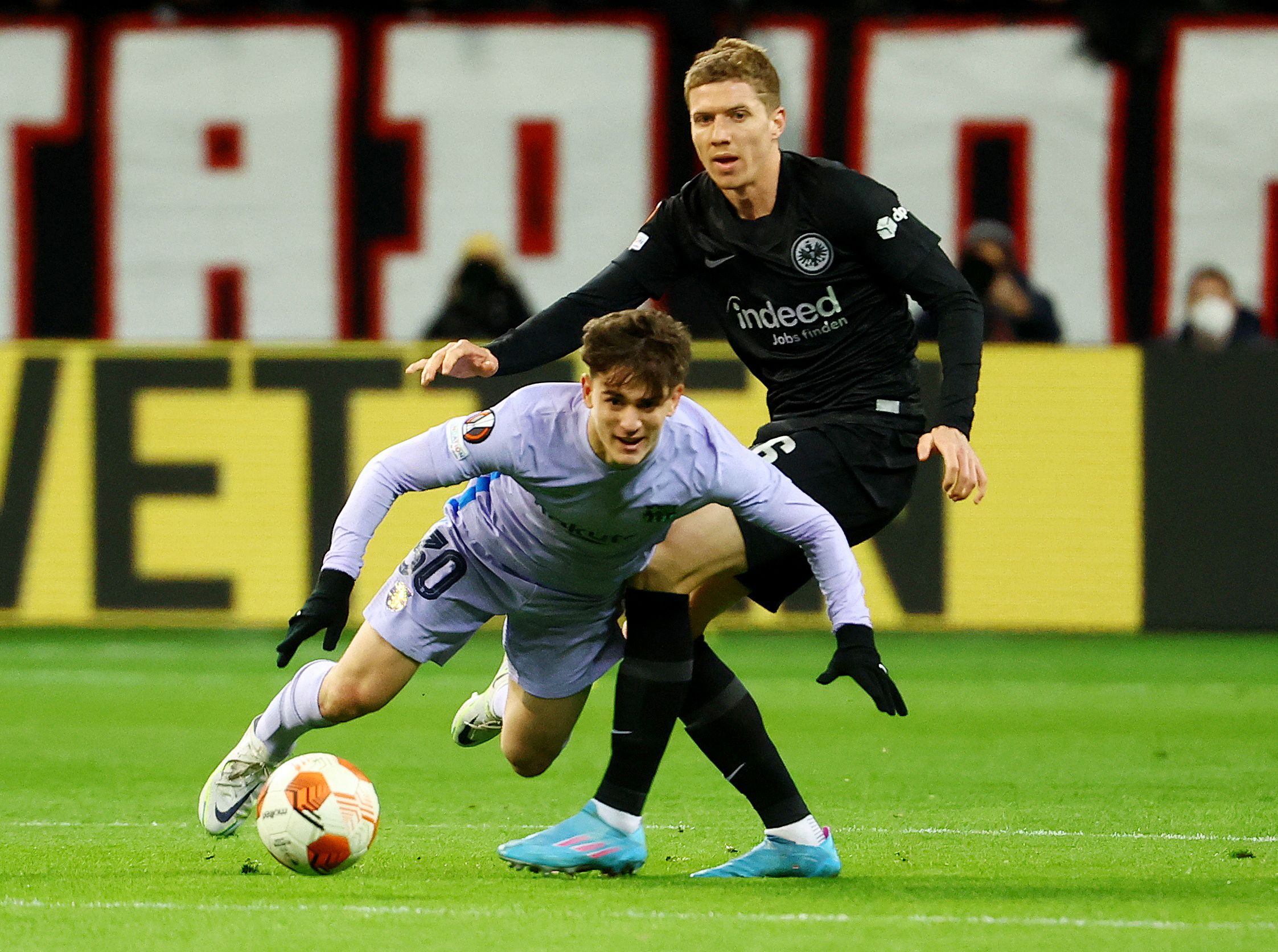Soccer Football - Europa League - Quarter Final - First Leg - Eintracht Frankfurt v FC Barcelona - Deutsche Bank Park, Frankfurt, Germany - April 7, 2022 FC Barcelona's Gavi in action with Eintracht Frankfurt's Kristijan Jakic REUTERS