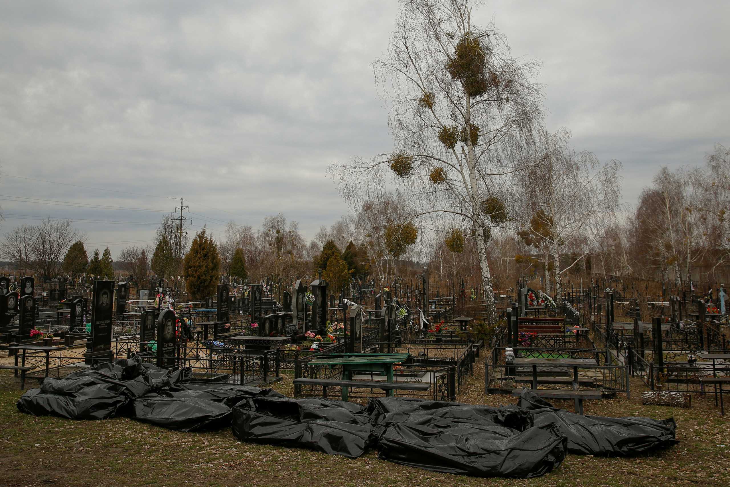 Bodies of civilians, collected from streets to local cemetery, are seen, as Russia's attack on Ukraine continues, in the town of Bucha, outside Kyiv, Ukraine April 6, 2022.  REUTERS