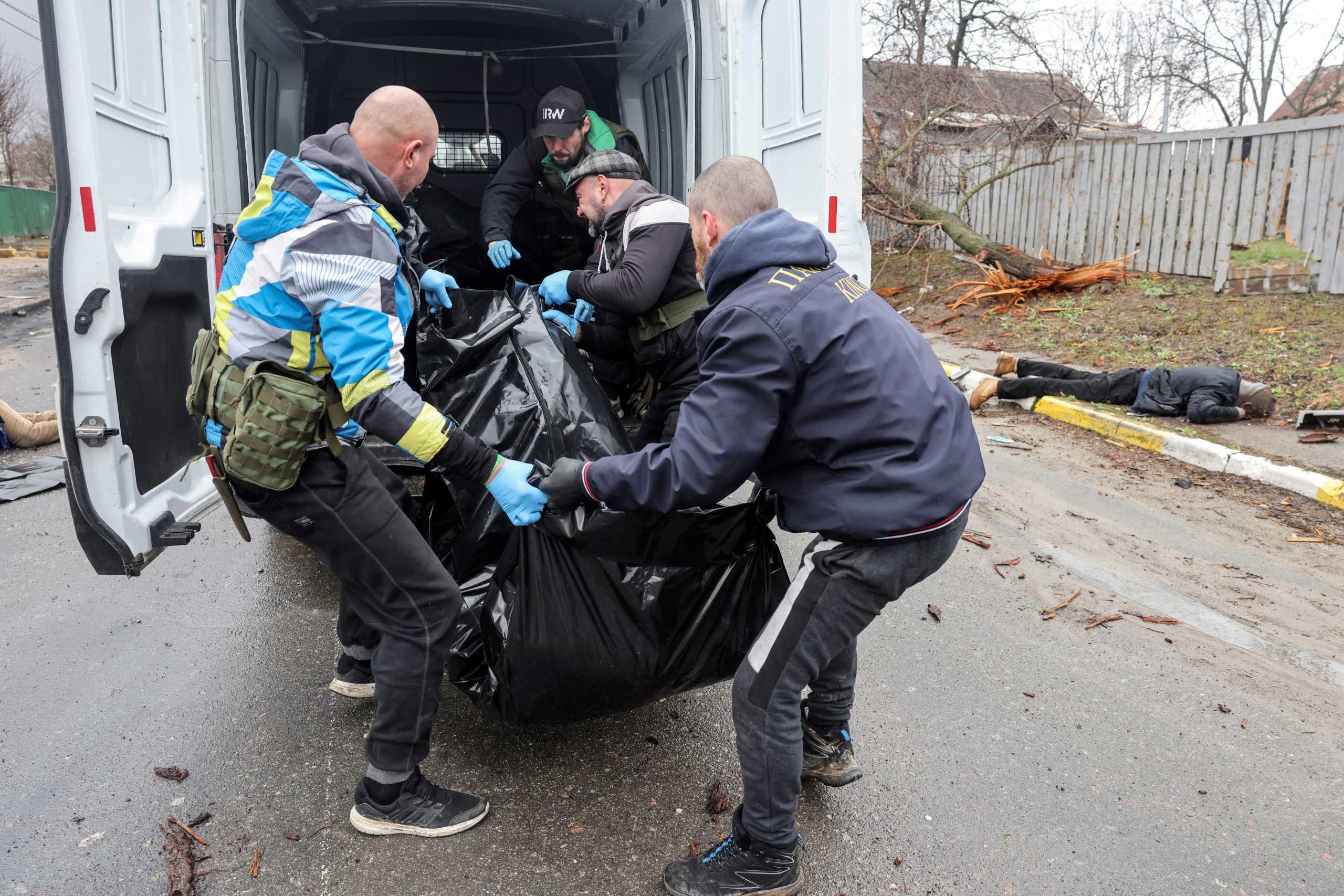 SENSITIVE MATERIAL. THIS IMAGE MAY OFFEND OR DISTURB Volunteers load the body of a civilian, who according to residents was killed by Russian soldiers, in a van, amid Russia's invasion on Ukraine, in Bucha, in Kyiv region, Ukraine, April 3, 2022. REUTERS