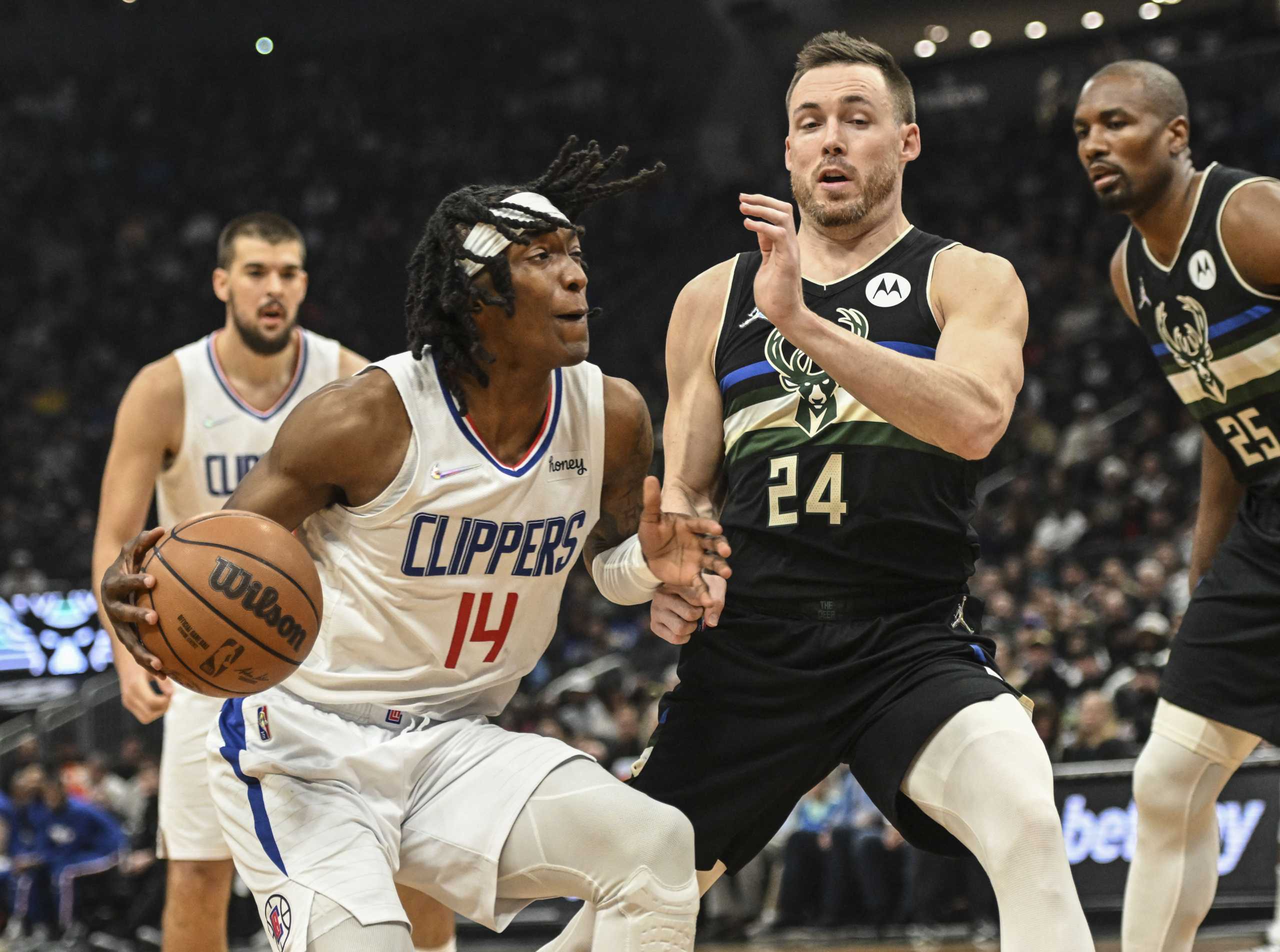 Apr 1, 2022; Milwaukee, Wisconsin, USA;  LA Clippers guard Terance Mann (14) drives for the basket against Milwaukee Bucks guard Pat Connaughton (24) in the first quarter at Fiserv Forum. Mandatory Credit: Benny Sieu-USA TODAY Sports