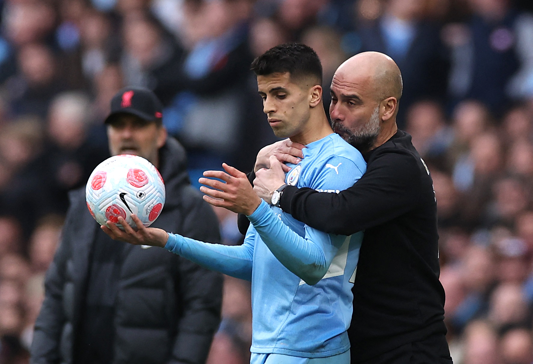 Soccer Football - Premier League - Manchester City v Liverpool - Etihad Stadium, Manchester, Britain - April 10, 2022 Manchester City's Joao Cancelo and manager Pep Guardiola REUTERS