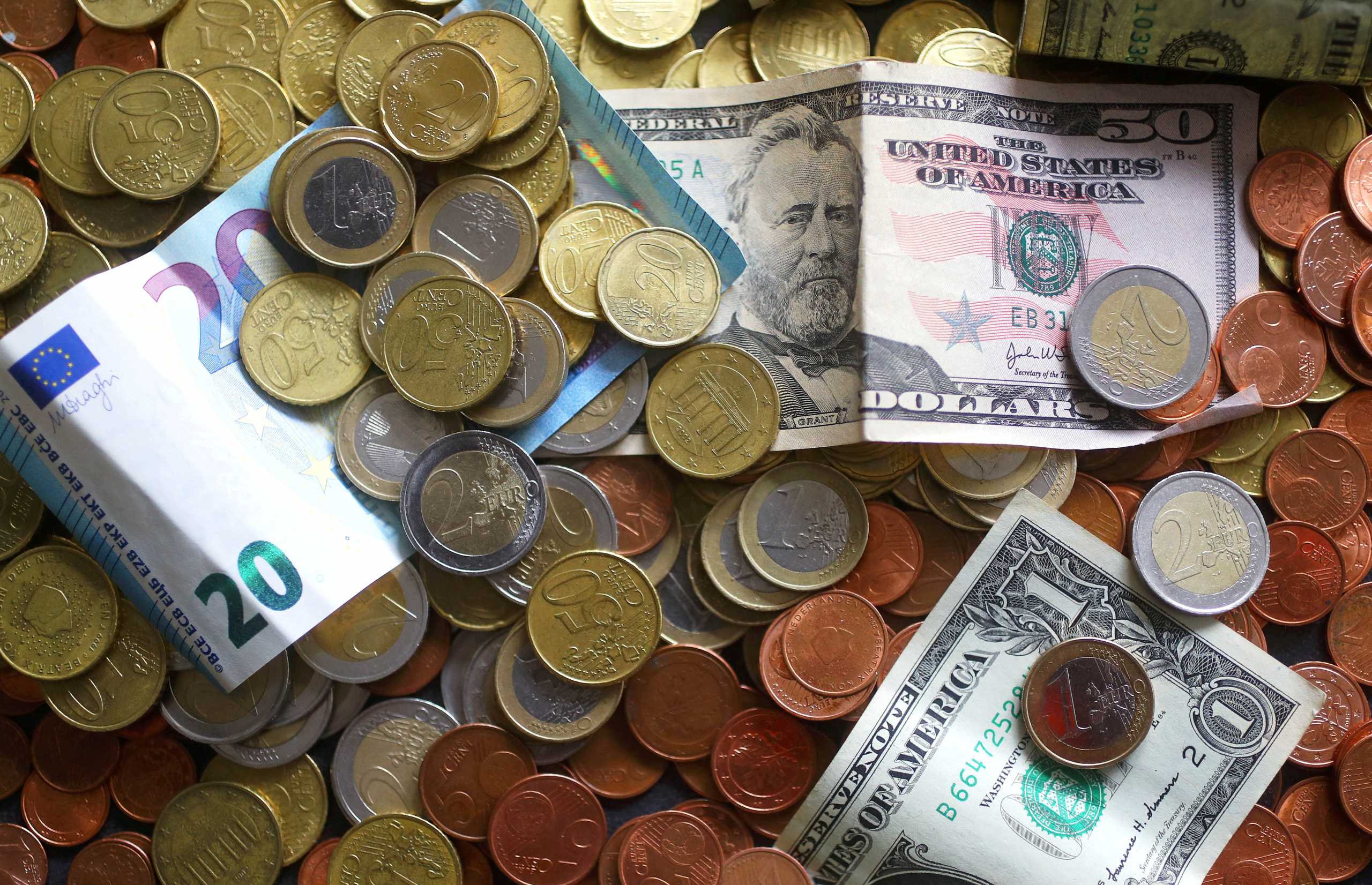 FILE PHOTO: An illustration picture shows euro and US dollar banknotes and coins, April 8, 2017.  REUTERS